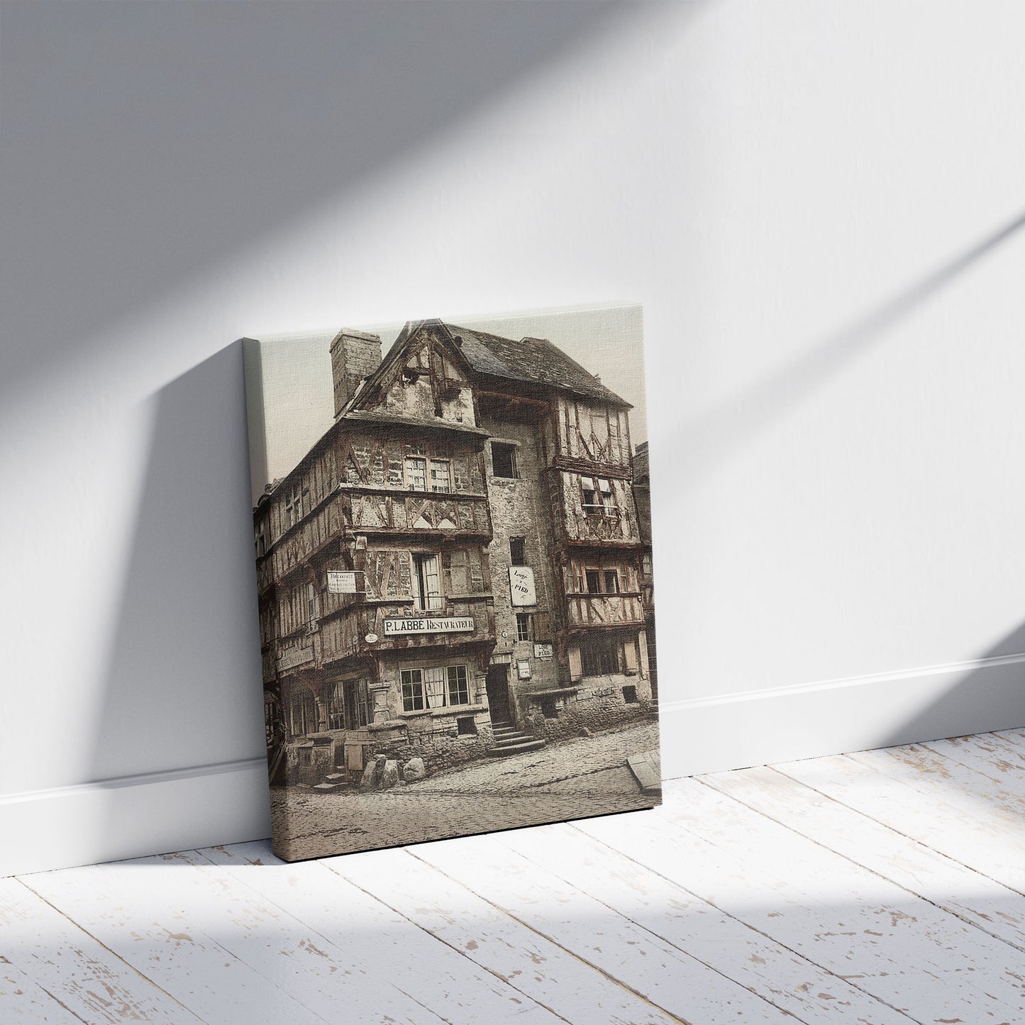 A picture of Bayeux Vielle Maison De La Rue Saint-Martin--Old house in Rue St. Martin, Bayeux, France, a mockup of the print leaning against a wall
