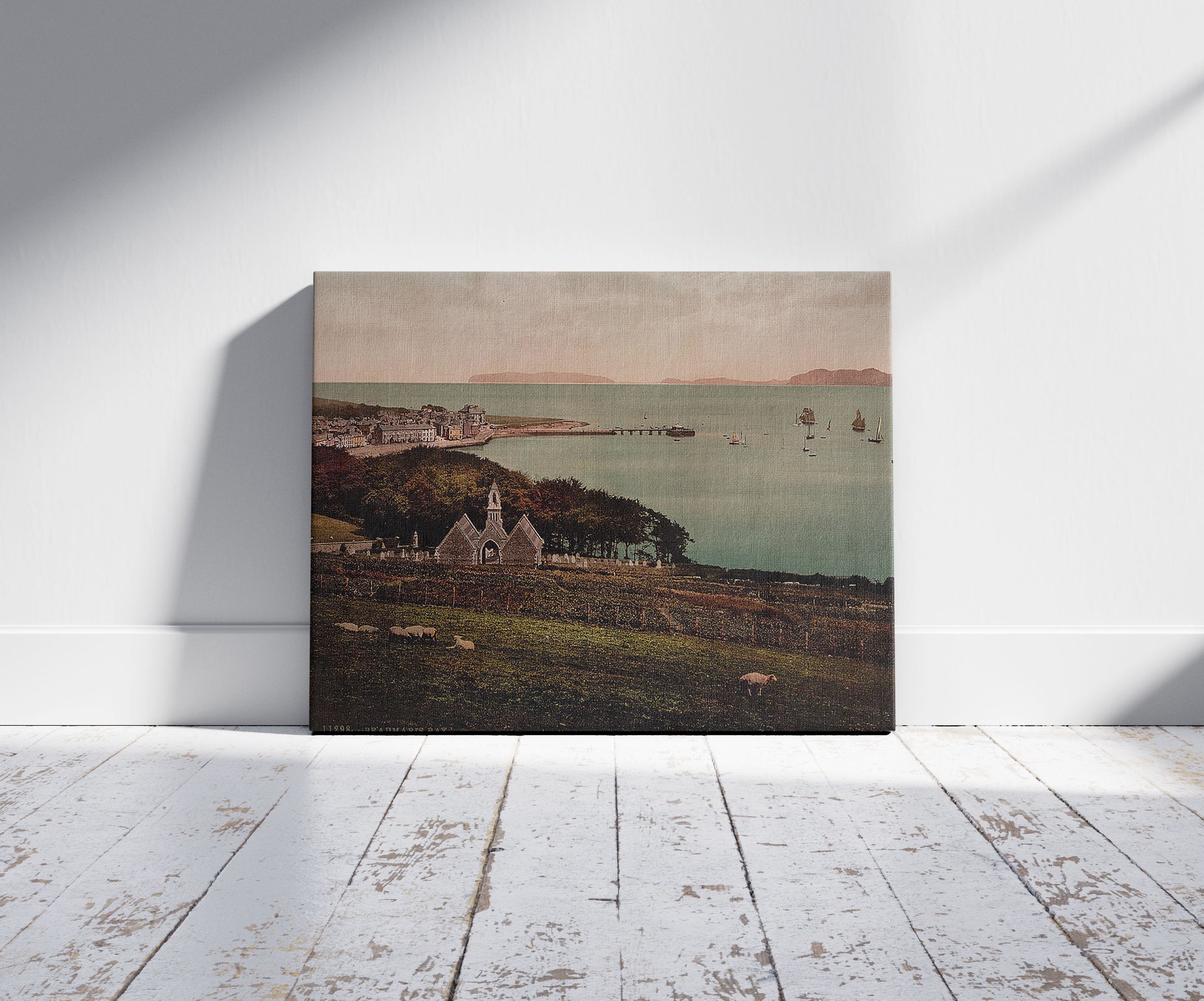 A picture of Beaumaris Bay, Beaumaris Castle, Wales, a mockup of the print leaning against a wall