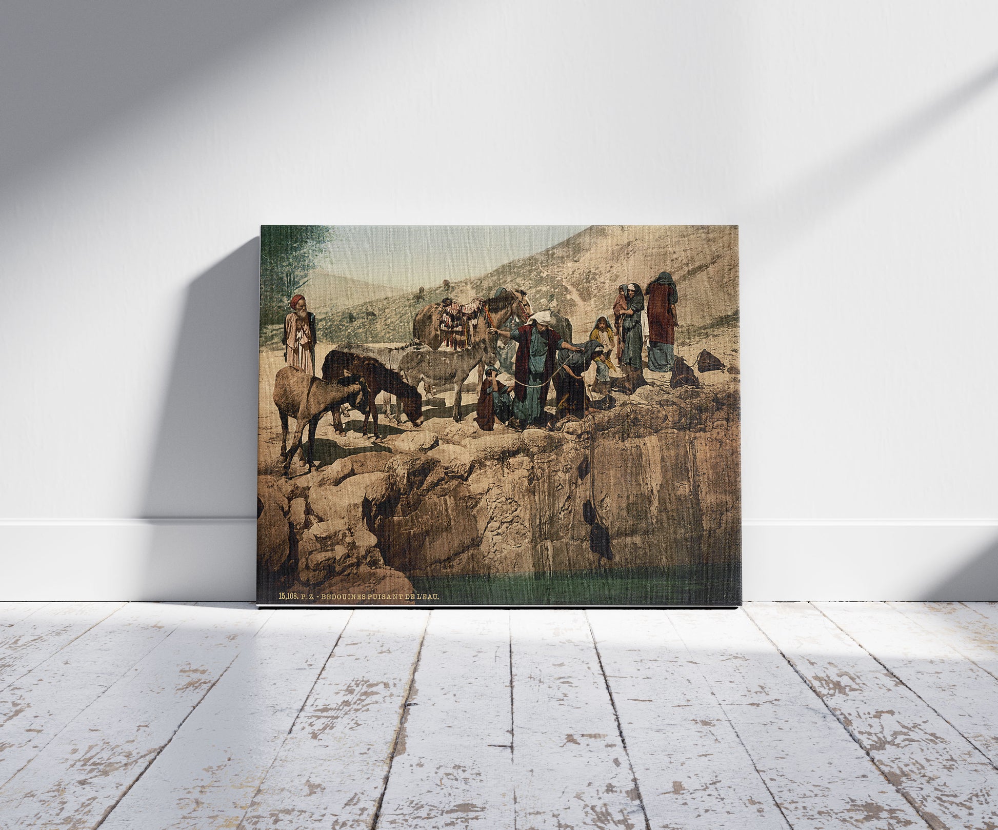 A picture of Bedouins drawing water, Holy Land, a mockup of the print leaning against a wall