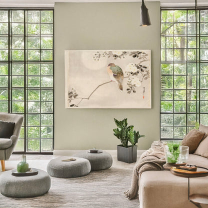A picture of Bird perched on a branch of a blossoming tree, a mockup of the print leaning against a wall