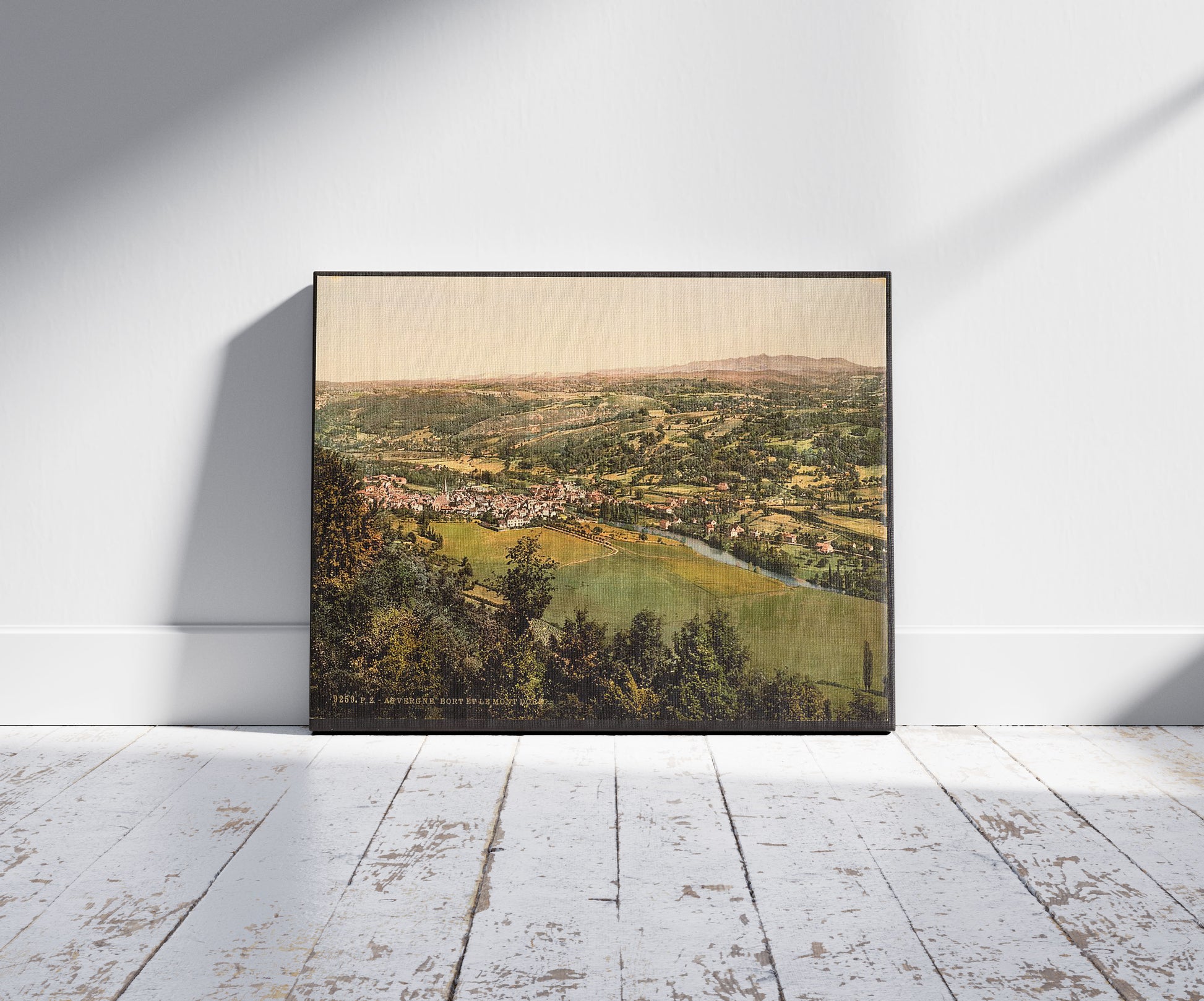 A picture of Bort and Mont Dore, Auvergne Mountains, France, a mockup of the print leaning against a wall