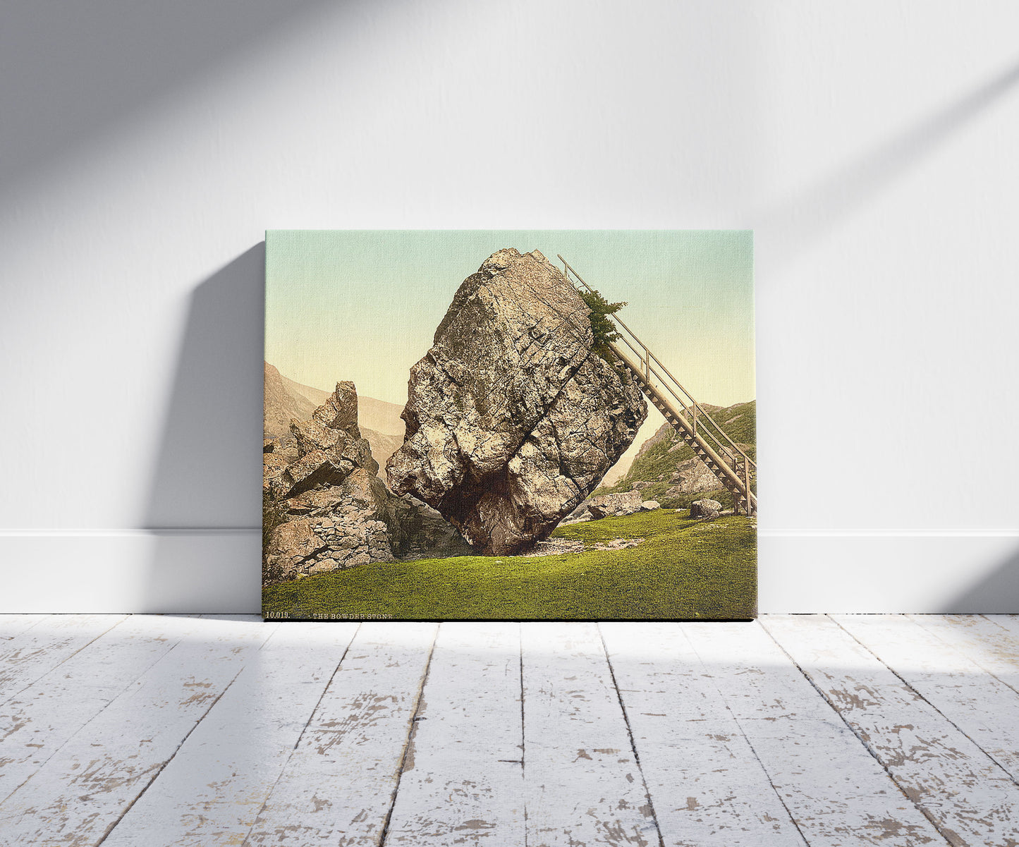 A picture of Bowder Stone, Lake District, England, a mockup of the print leaning against a wall