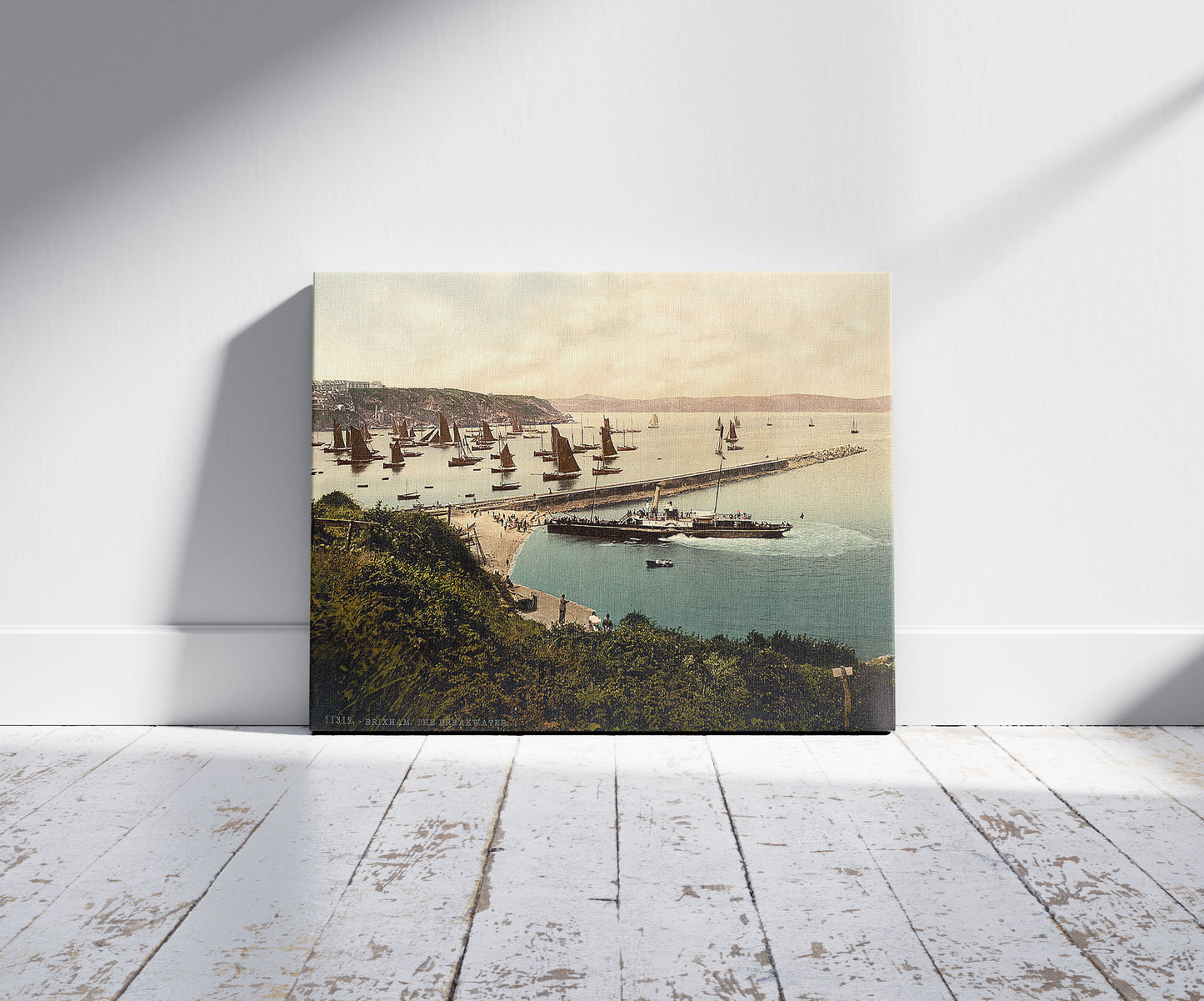 A picture of Breakwater, Brixham, England, a mockup of the print leaning against a wall