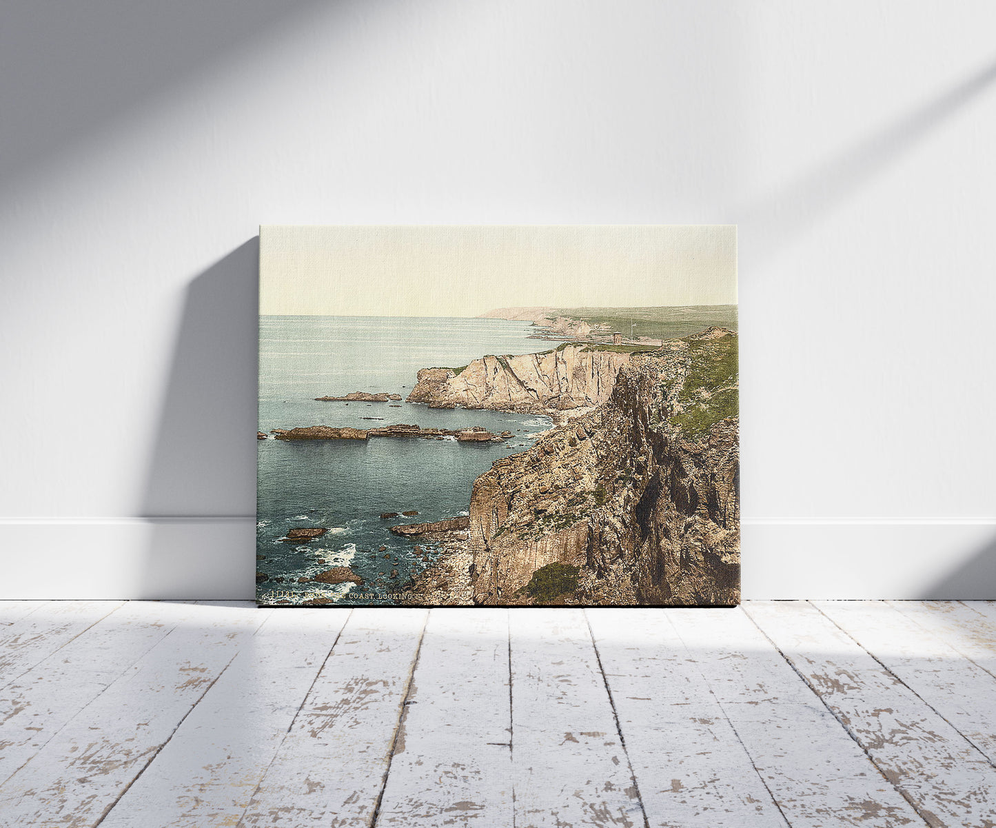 A picture of Bude, the coast looking N.E., Cornwall, England, a mockup of the print leaning against a wall