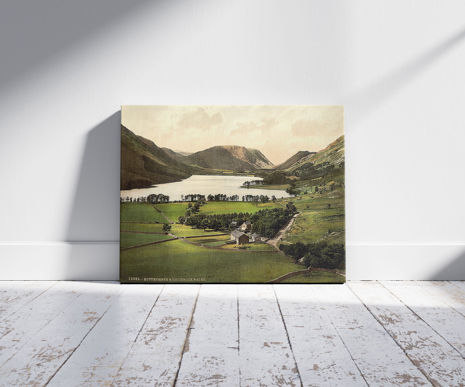 A picture of Buttermere and Crummock Water, Lake District, England, a mockup of the print leaning against a wall