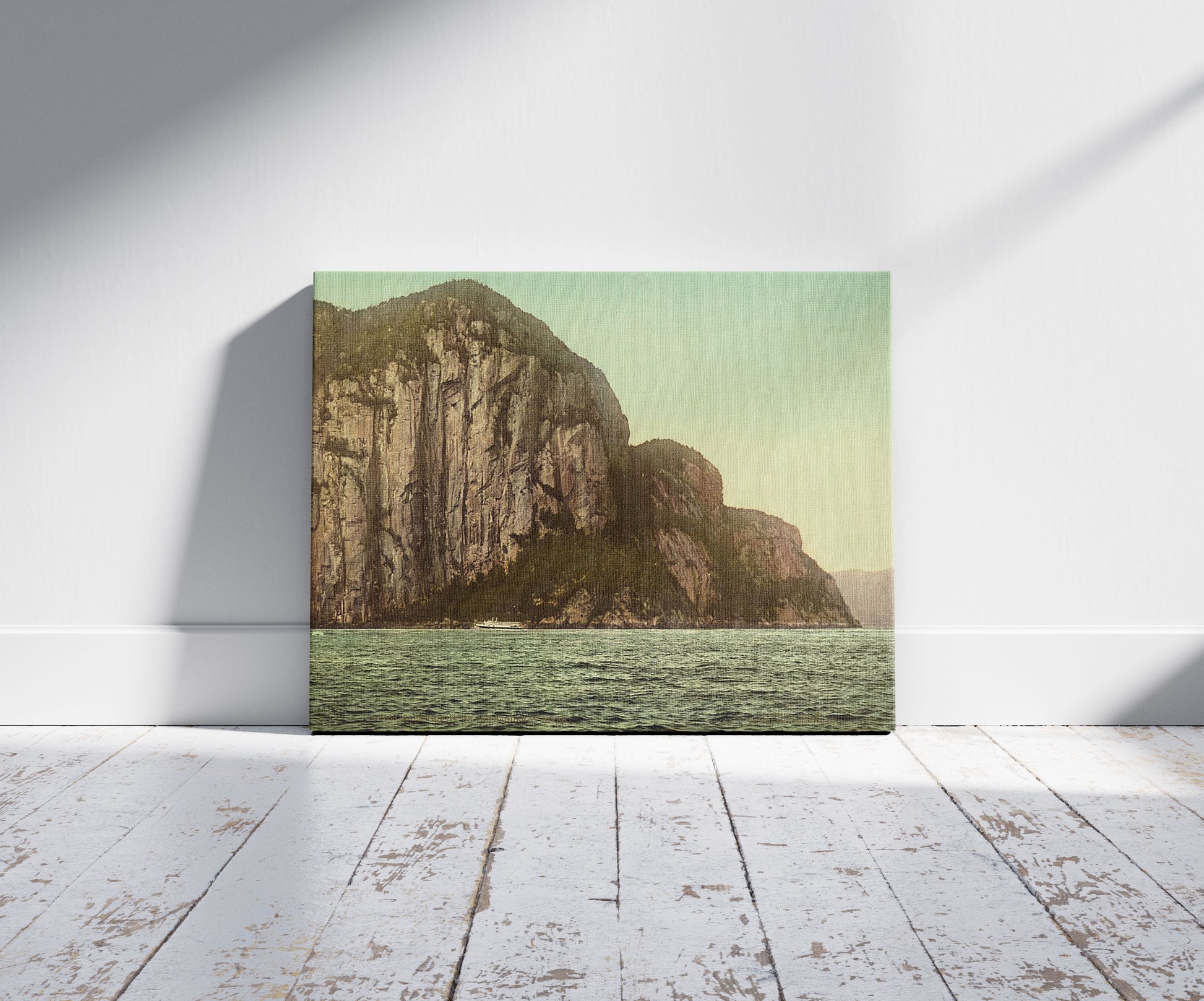 A picture of Cape Trinity on the Saguenay River, a mockup of the print leaning against a wall