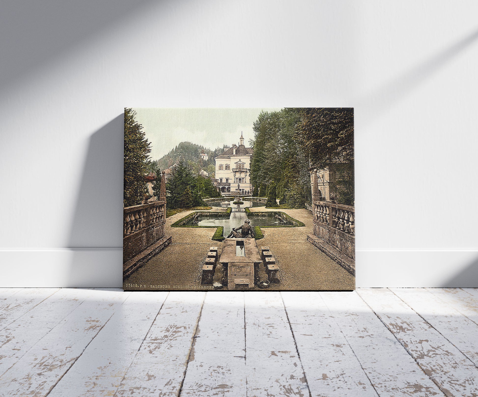 A picture of Castle Hellbrun (i.e., Hellbrunn), Salzburg, Austro-Hungary, a mockup of the print leaning against a wall