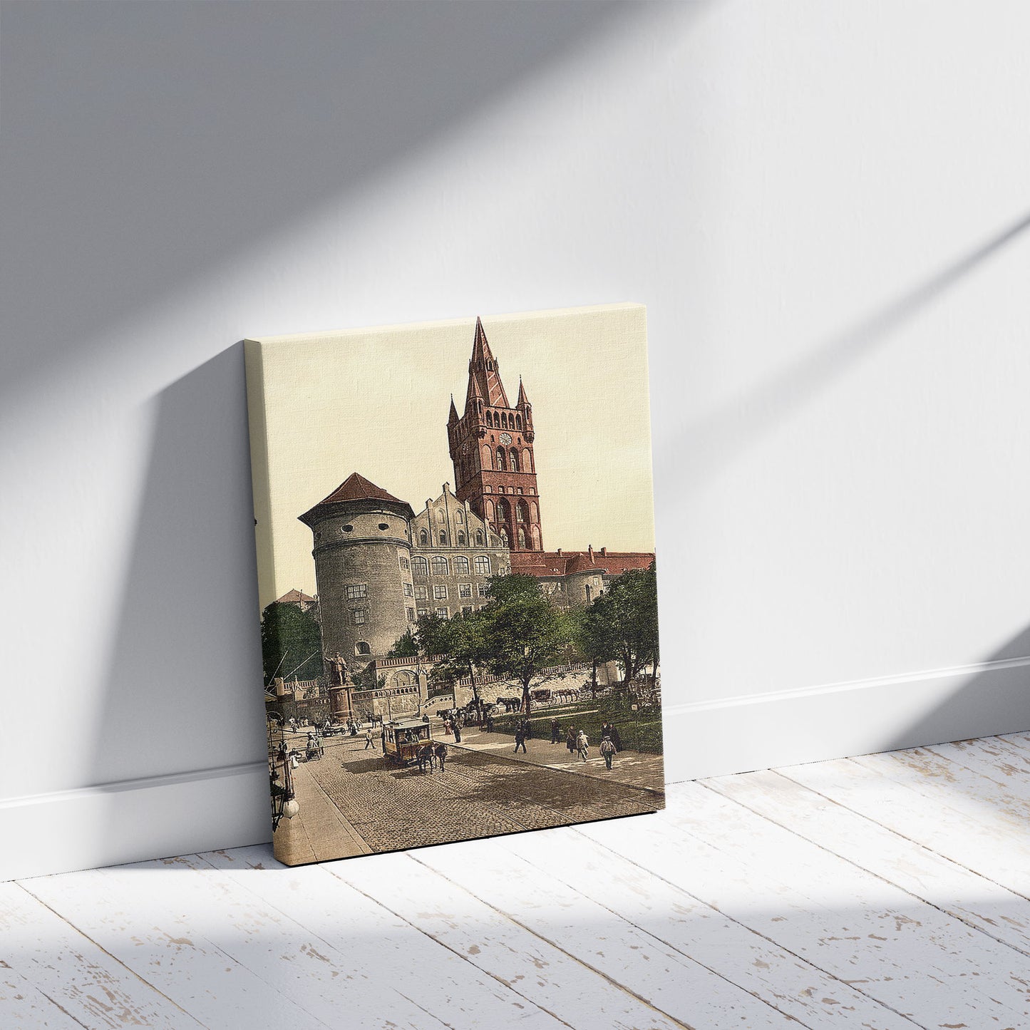 A picture of Castle tower and Emperor William's Monument, Konigsberg,  East Prussia, Germany (i.e., Kaliningrad, Kaliningradskai︠a︡ oblastʹ, Russia), a mockup of the print leaning against a wall