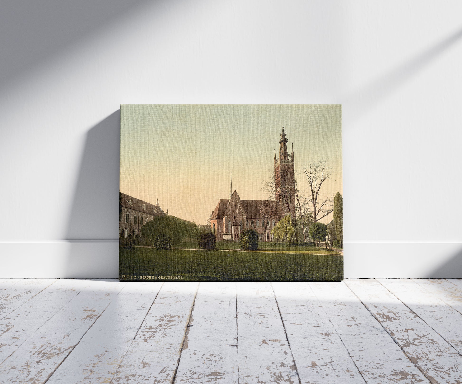 A picture of Church and Grey House, park of Worlitz, Anhalt, Germany, a mockup of the print leaning against a wall