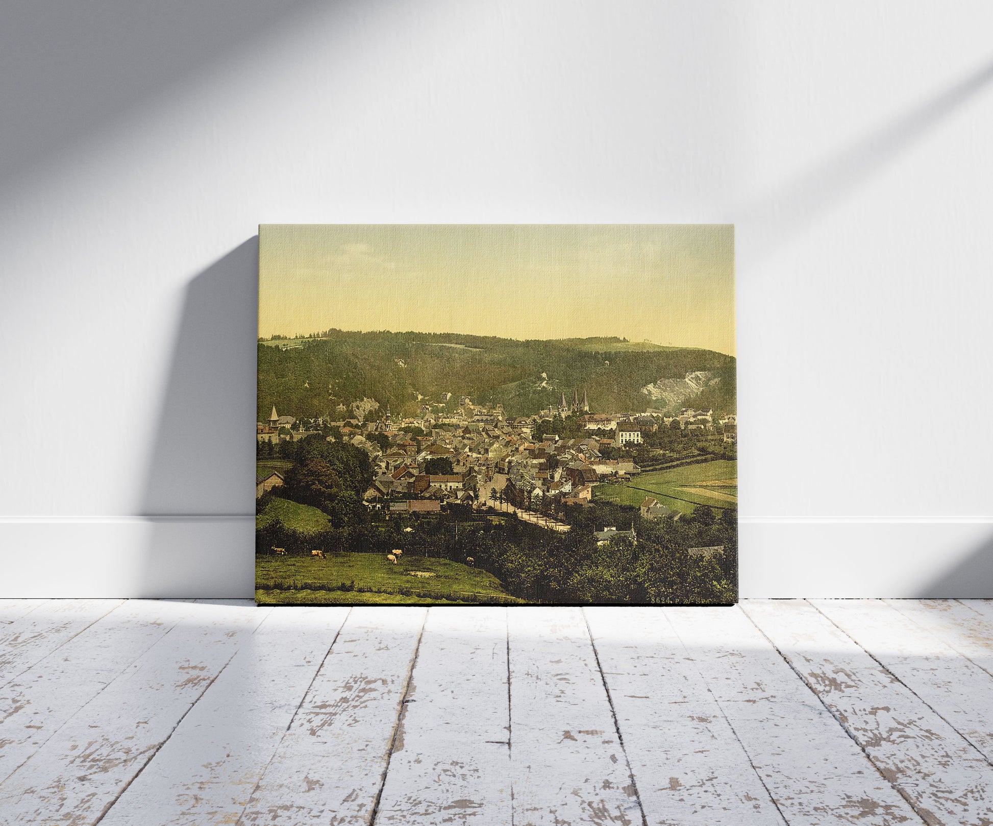 A picture of Cityscape of Spa, Belgium, a mockup of the print leaning against a wall