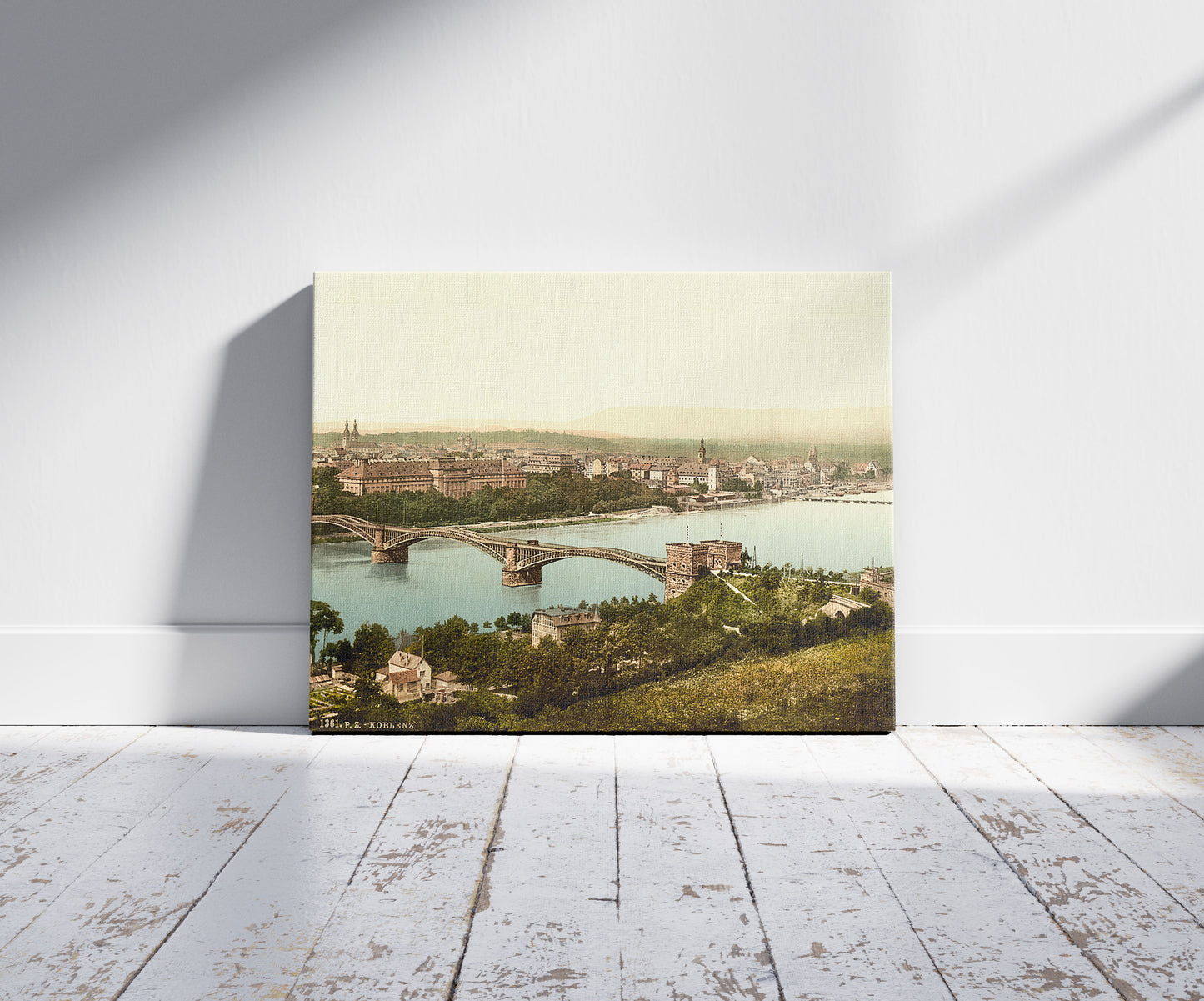 A picture of Coblenz, the Rhine, Germany, a mockup of the print leaning against a wall