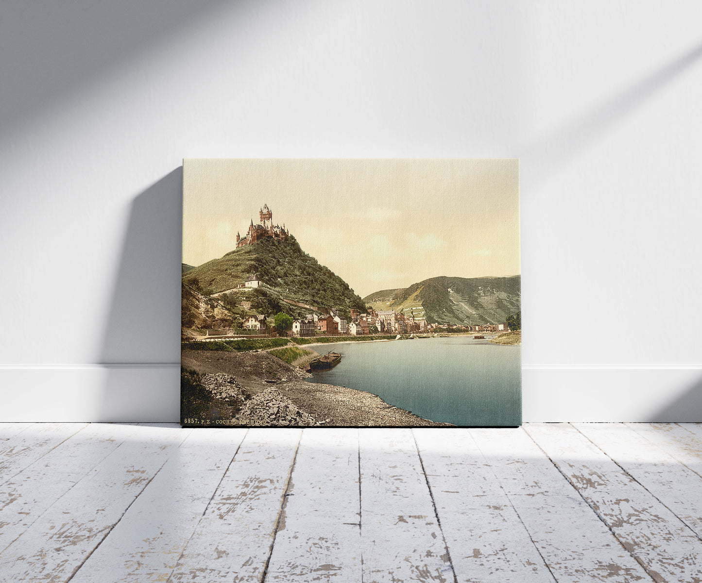 A picture of Cochem and castle, Moselle, valley of, Germany, a mockup of the print leaning against a wall