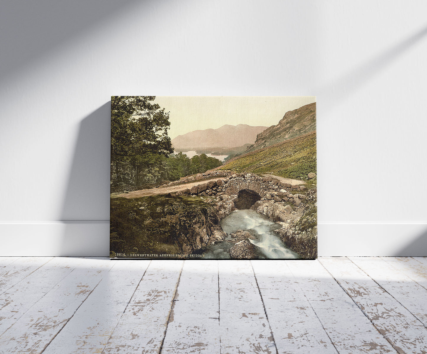 A picture of Derwentwater, Ashness Bridge and Skiddaw, Lake District, England, a mockup of the print leaning against a wall