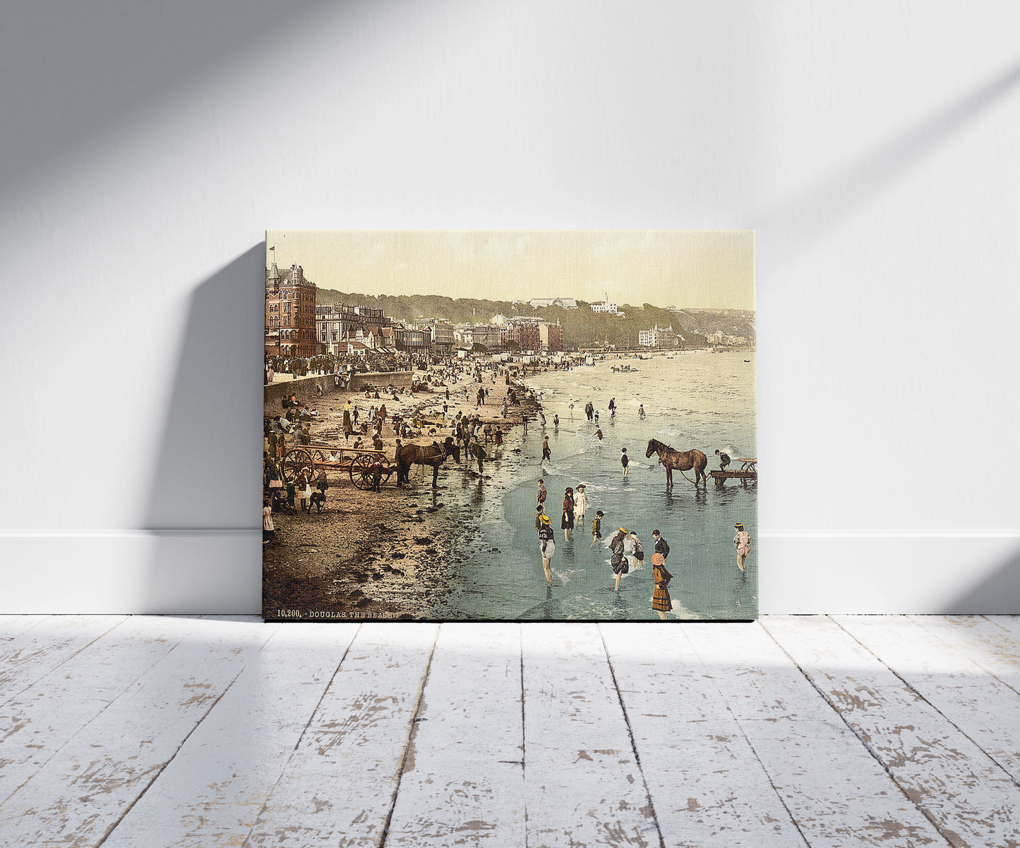 A picture of Douglas, the beach, Isle of Man, a mockup of the print leaning against a wall