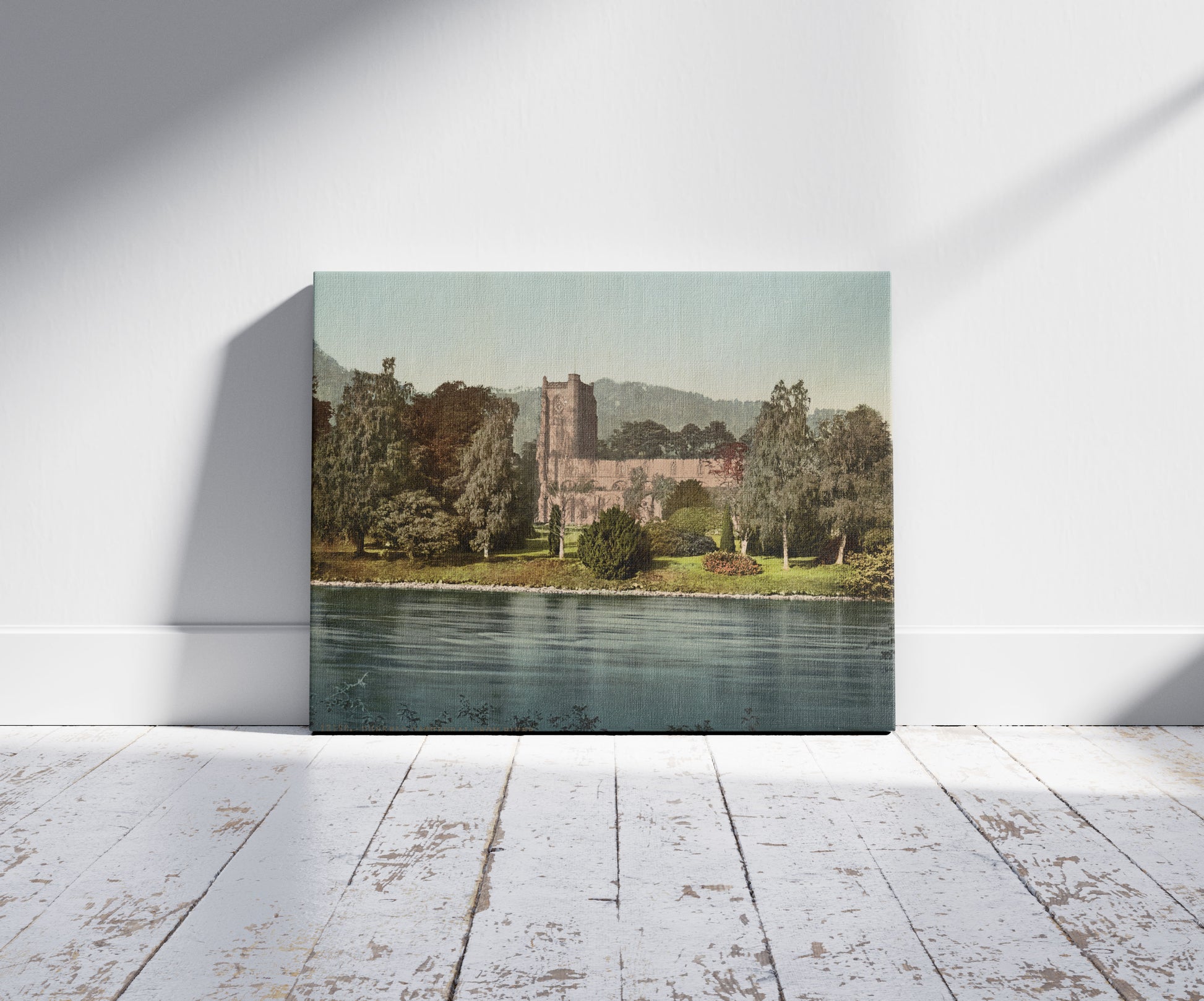 A picture of Dunkeld Cathedral from river, a mockup of the print leaning against a wall