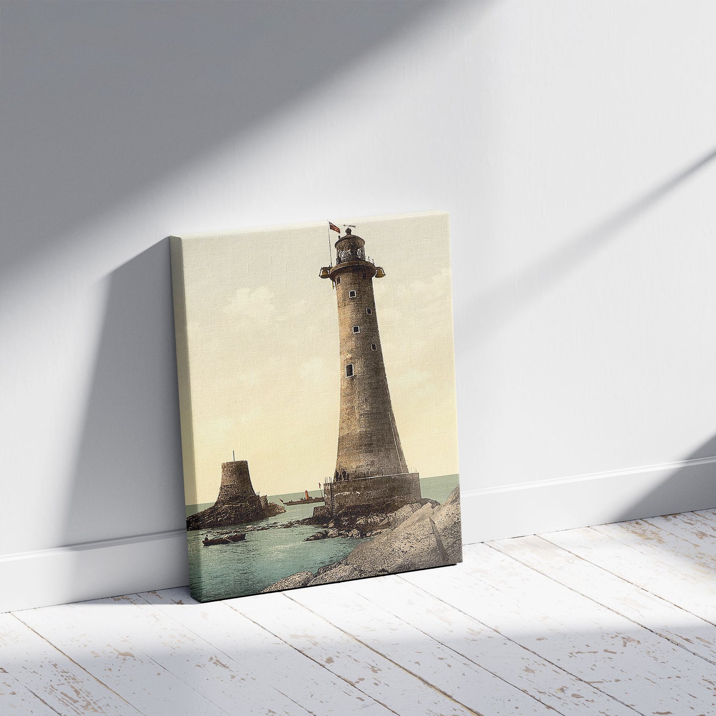 A picture of Eddystone Lighthouse, Plymouth, England, a mockup of the print leaning against a wall