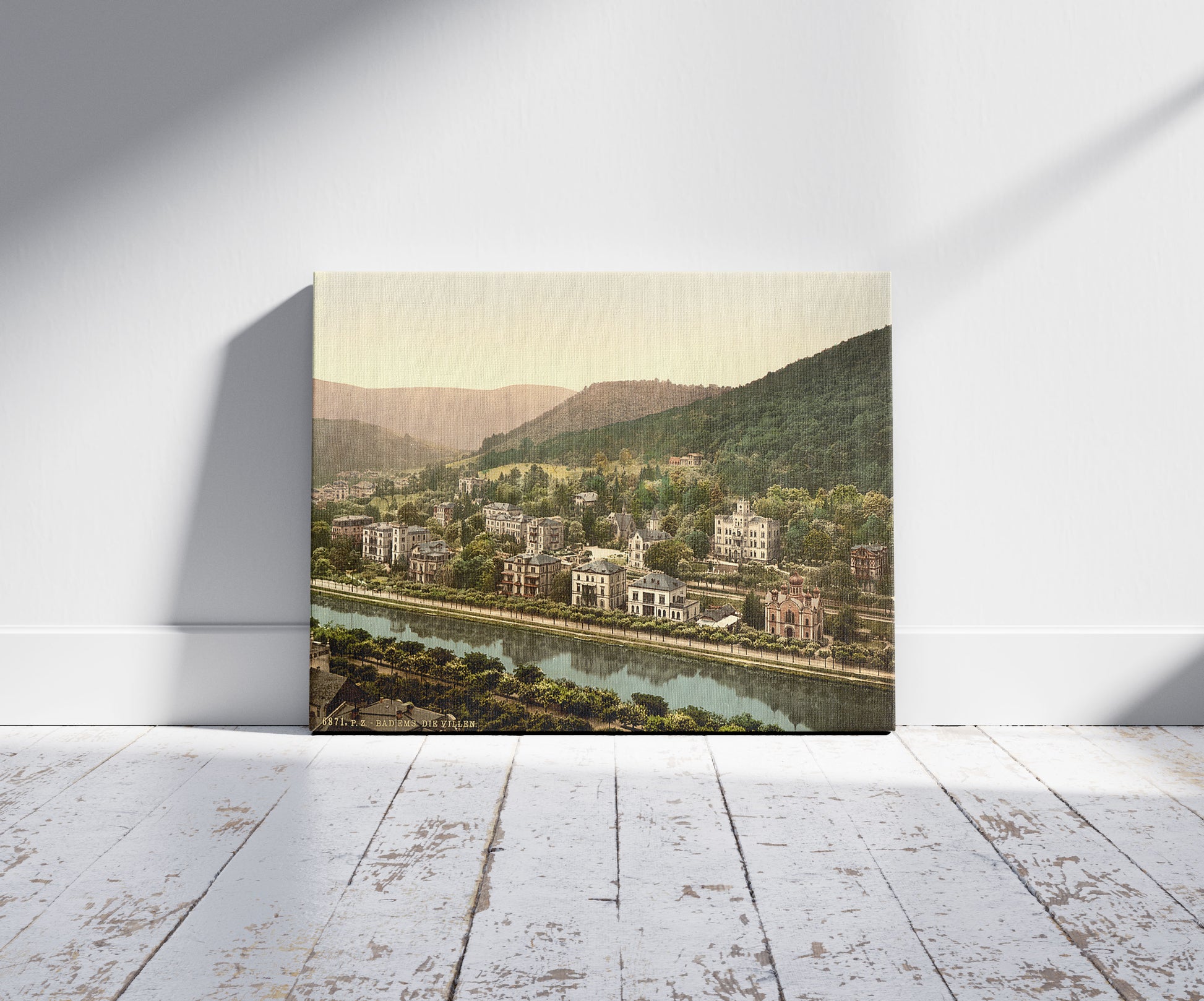 A picture of Ems-Les Bains (i.e., Bad Ems), Hesse-Nassau, Germany, a mockup of the print leaning against a wall