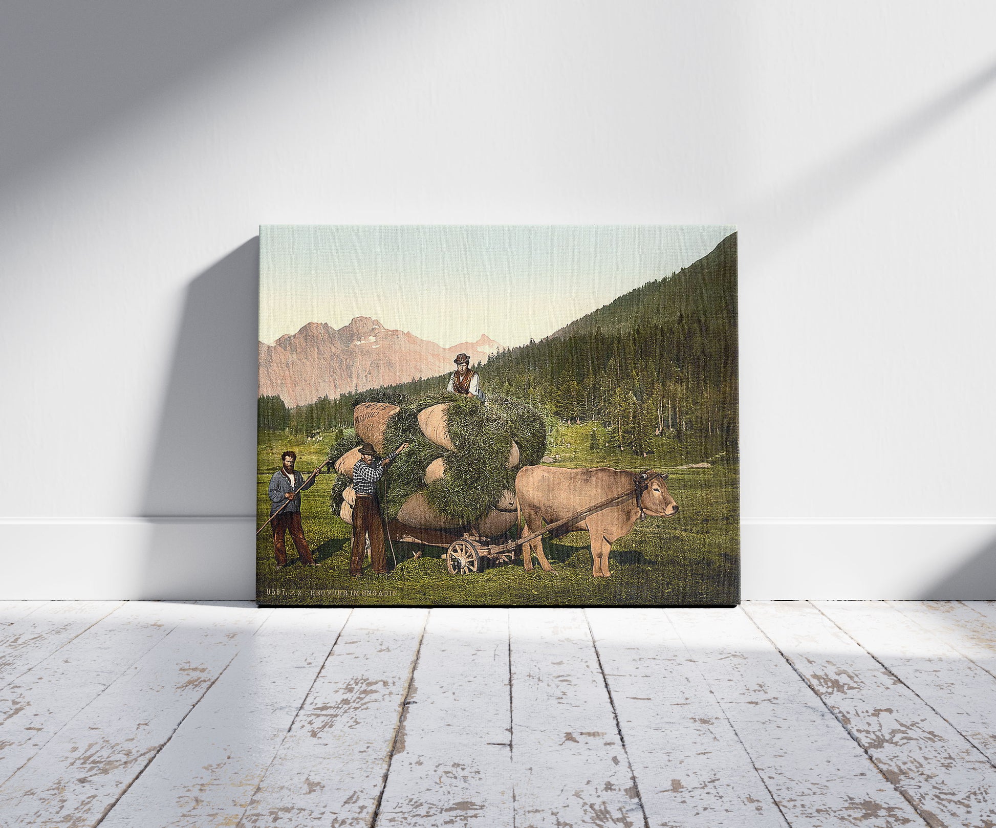 A picture of Engadine, carrying hay in the Engadine, Grisons, Switzerland, a mockup of the print leaning against a wall