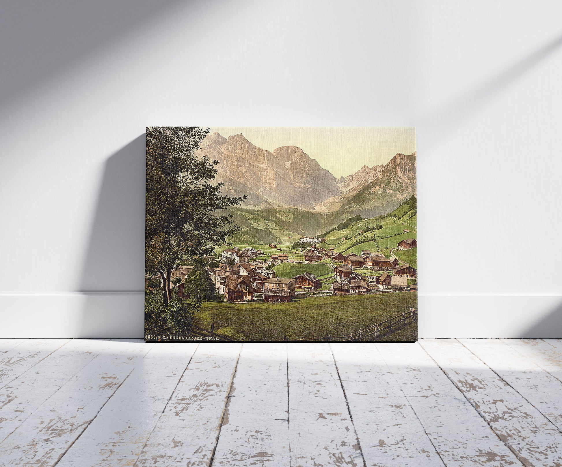 A picture of Engelberg Valley and Juchlipass, Bernese Oberland, Switzerland, a mockup of the print leaning against a wall