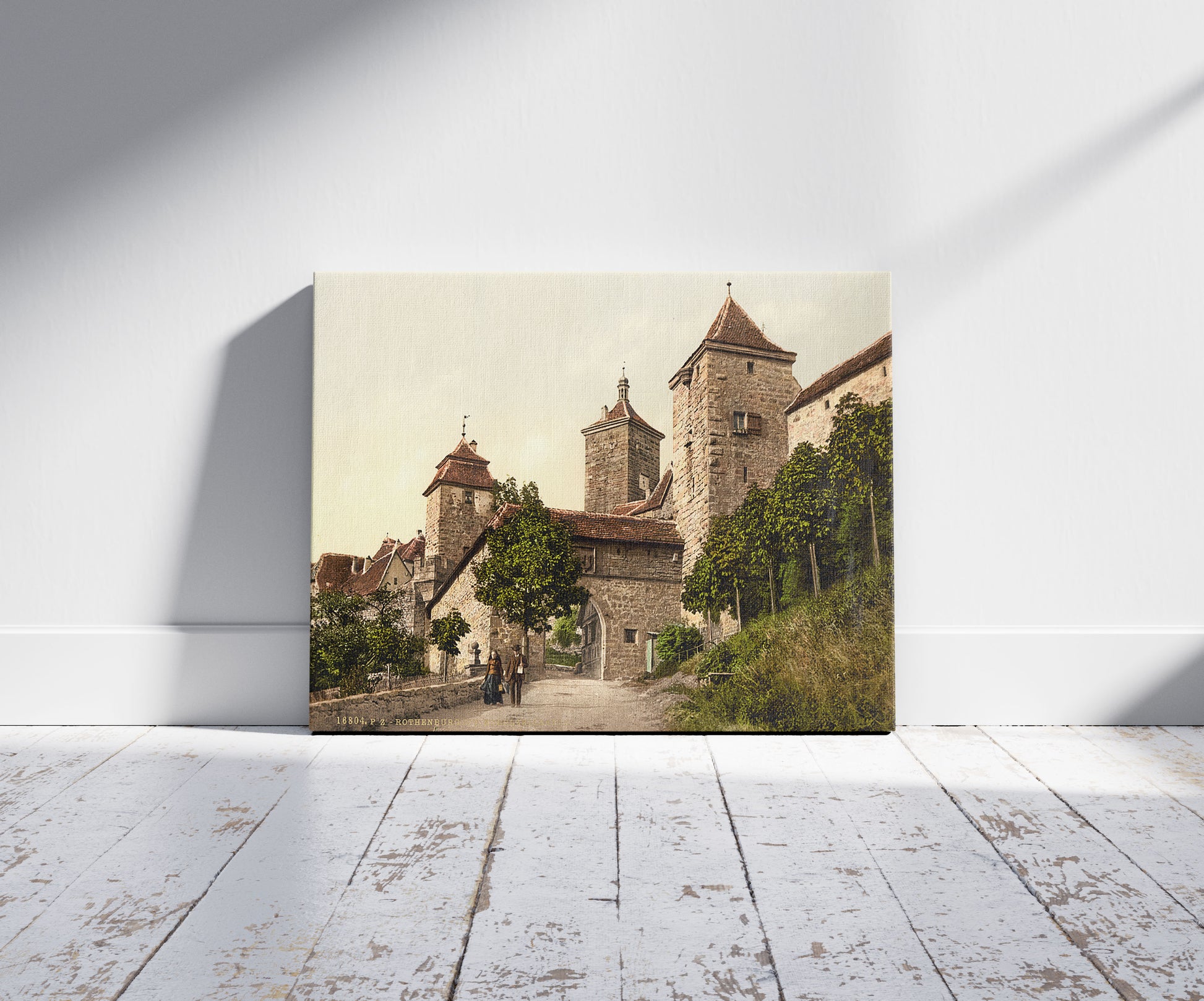 A picture of Entrance to Kobolzeller (i.e. Kobolzeller Tor), Rothenburg (i.e. ob der Tauber), Bavaria, Germany, a mockup of the print leaning against a wall