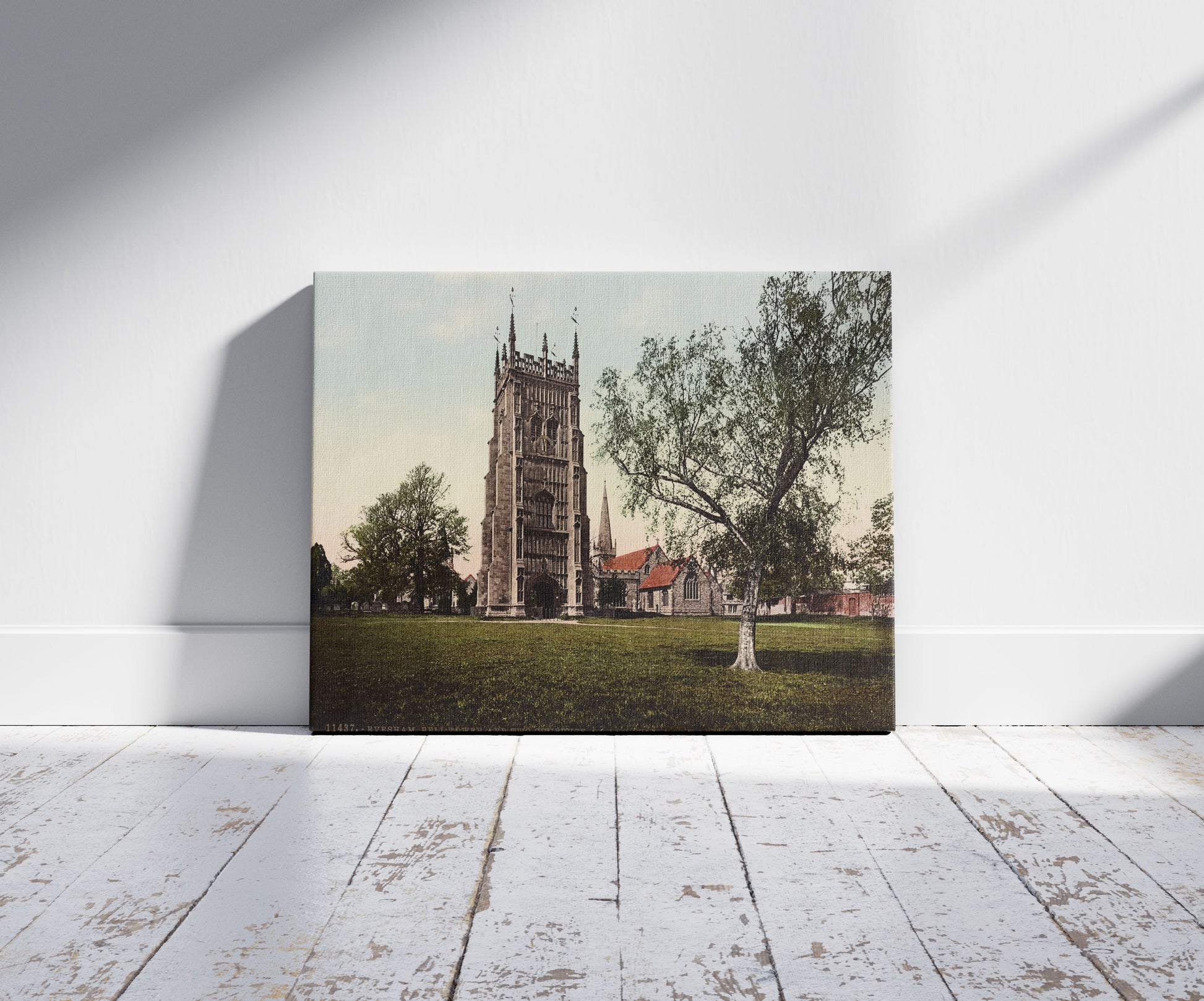 A picture of Evesham. Bell Tower and Two Churches, a mockup of the print leaning against a wall
