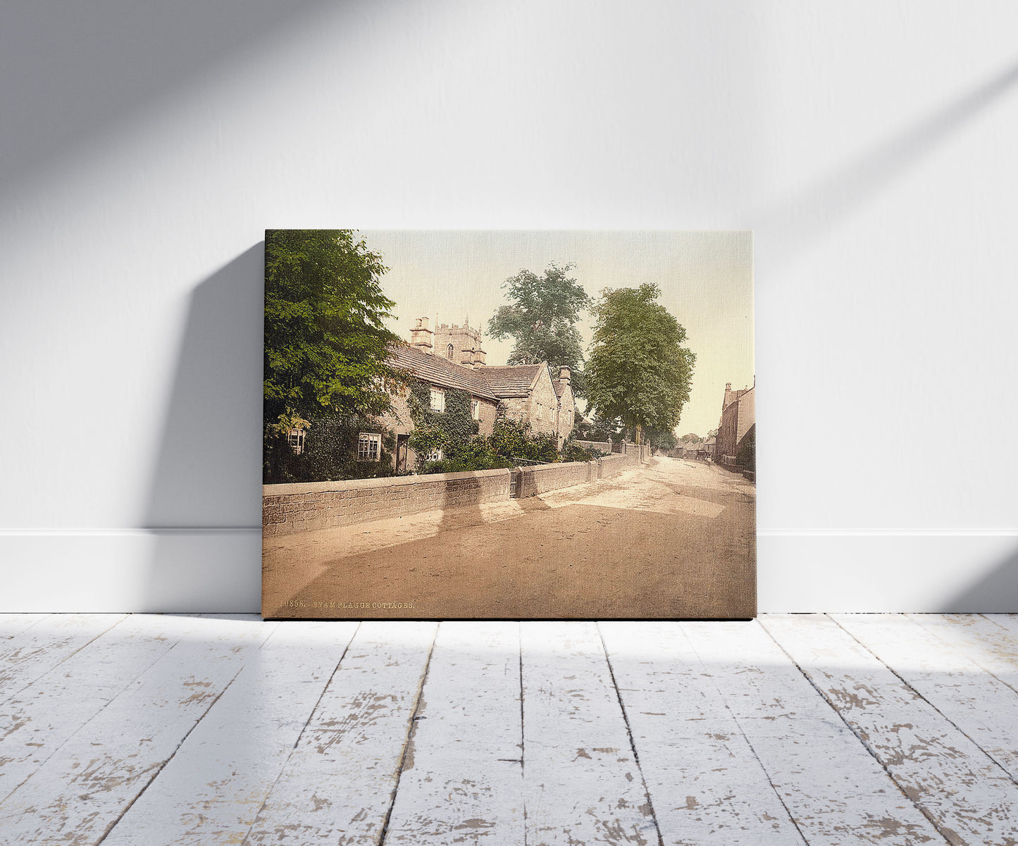 A picture of Eyam Plague Cottages, Derbyshire, England, a mockup of the print leaning against a wall
