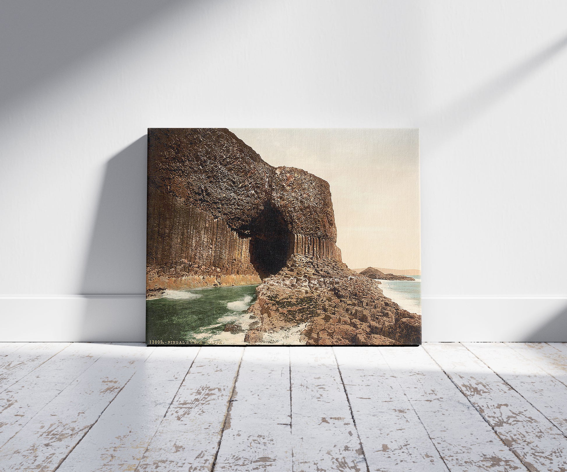 A picture of Fingal's Cave, Staffa, Scotland, a mockup of the print leaning against a wall