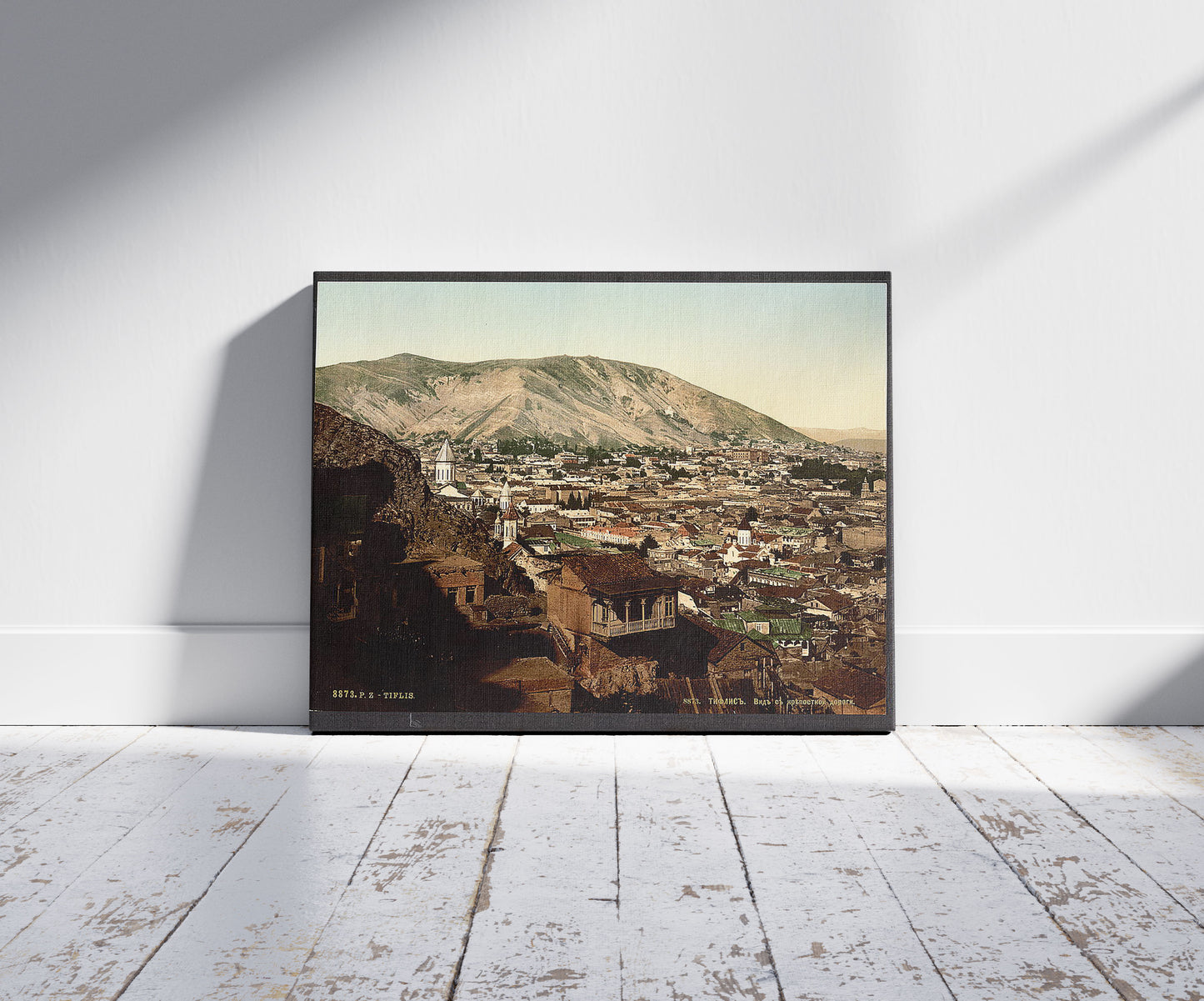 A picture of From the road to the fortress, Tiflis, Tbilisi, Georgia, a mockup of the print leaning against a wall