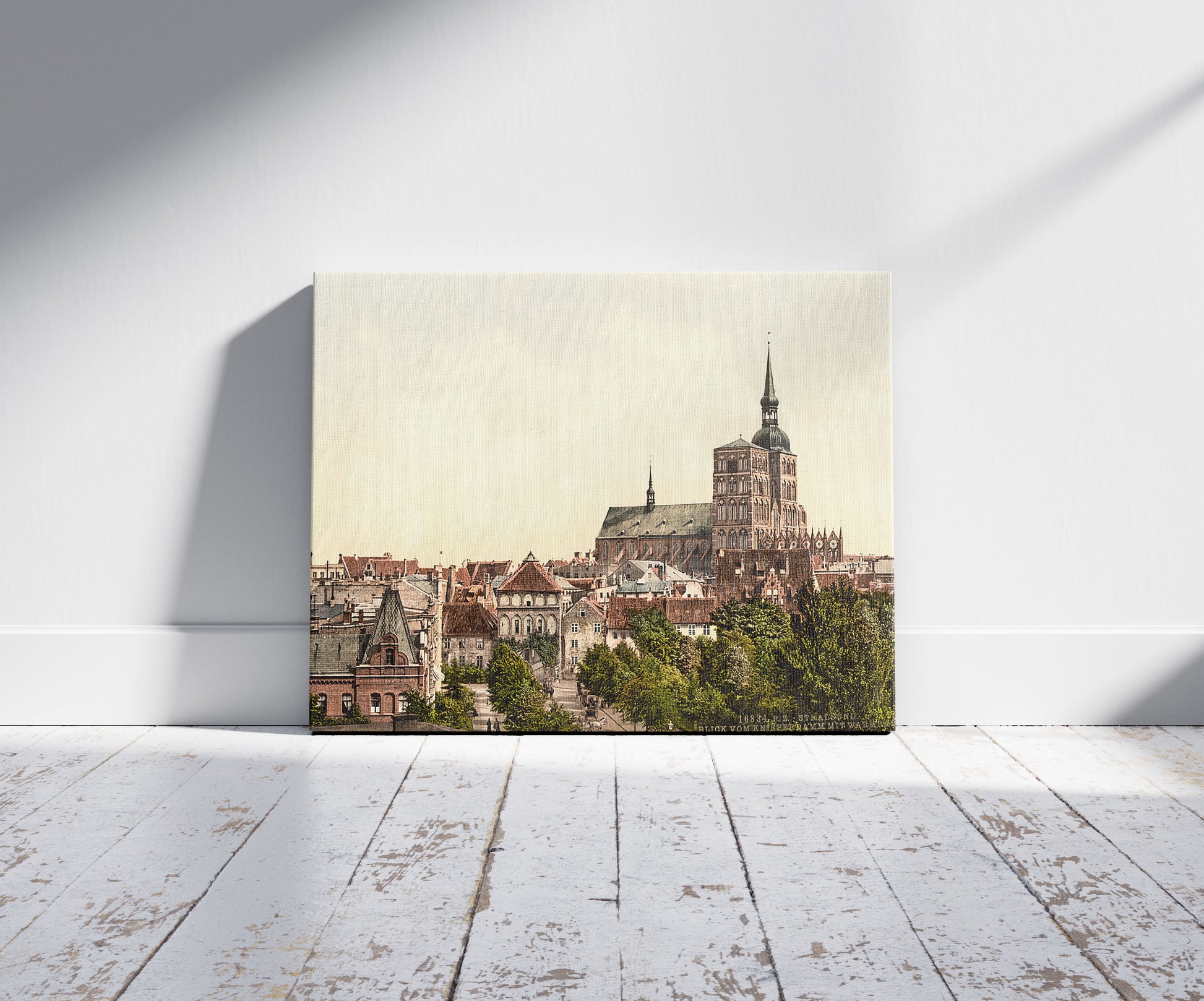 A picture of General view, from Knieperdamm, showing warm baths, Stralsund, Pomerania, Germany, a mockup of the print leaning against a wall