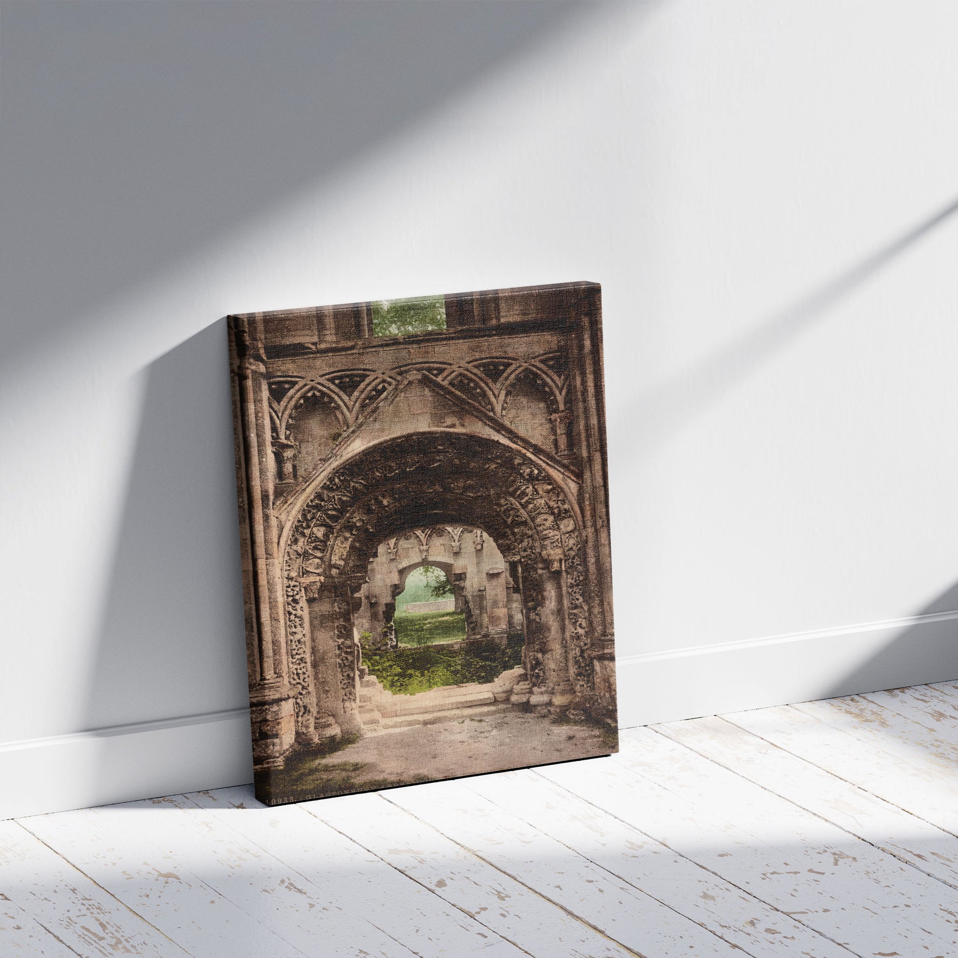 A picture of Glastonbury Abbey. Door. St. Joseph's Chapel, a mockup of the print leaning against a wall