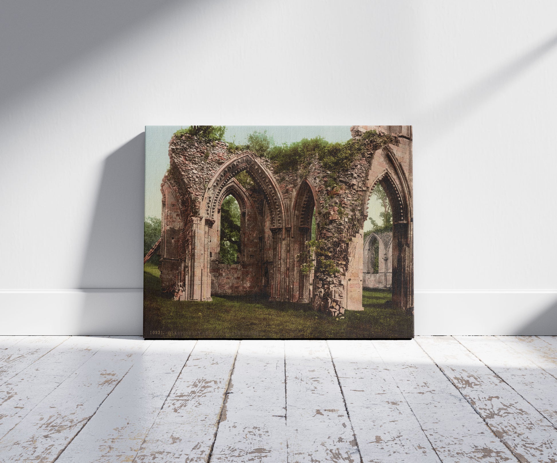 A picture of Glastonbury Abbey. The Lady Chapel, a mockup of the print leaning against a wall