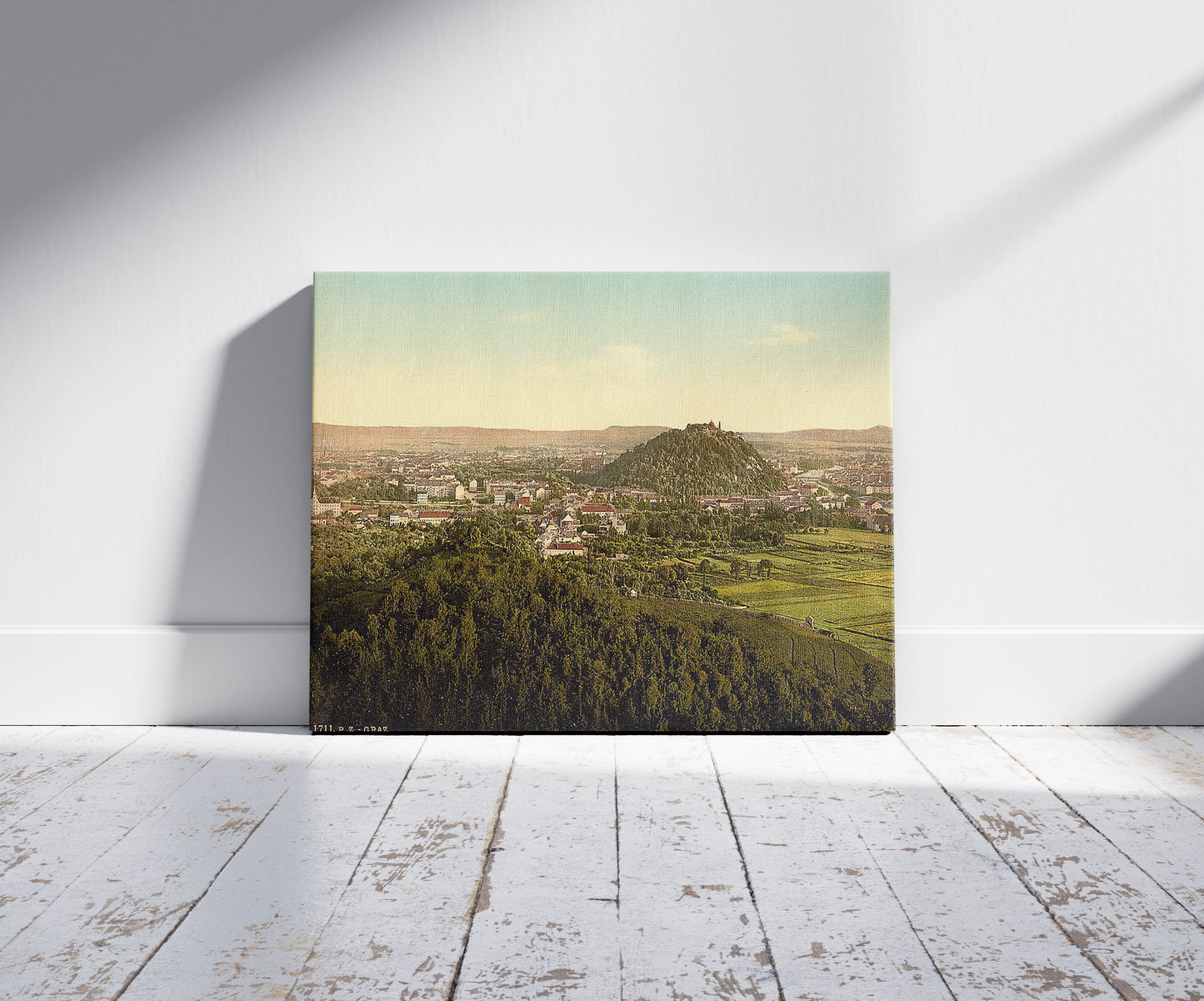 A picture of Graz, general view from the Rainer Kogel, Styria, Austro-Hungary, a mockup of the print leaning against a wall