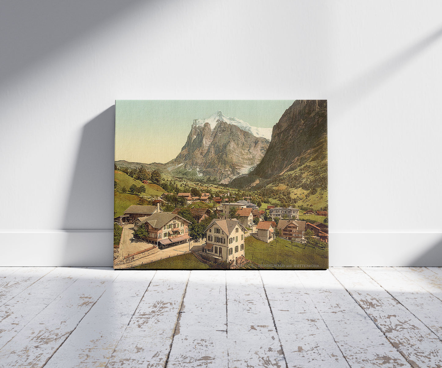A picture of Grindelwald and Wetterhorn Mountain, Bernese Oberland, Switzerland, a mockup of the print leaning against a wall