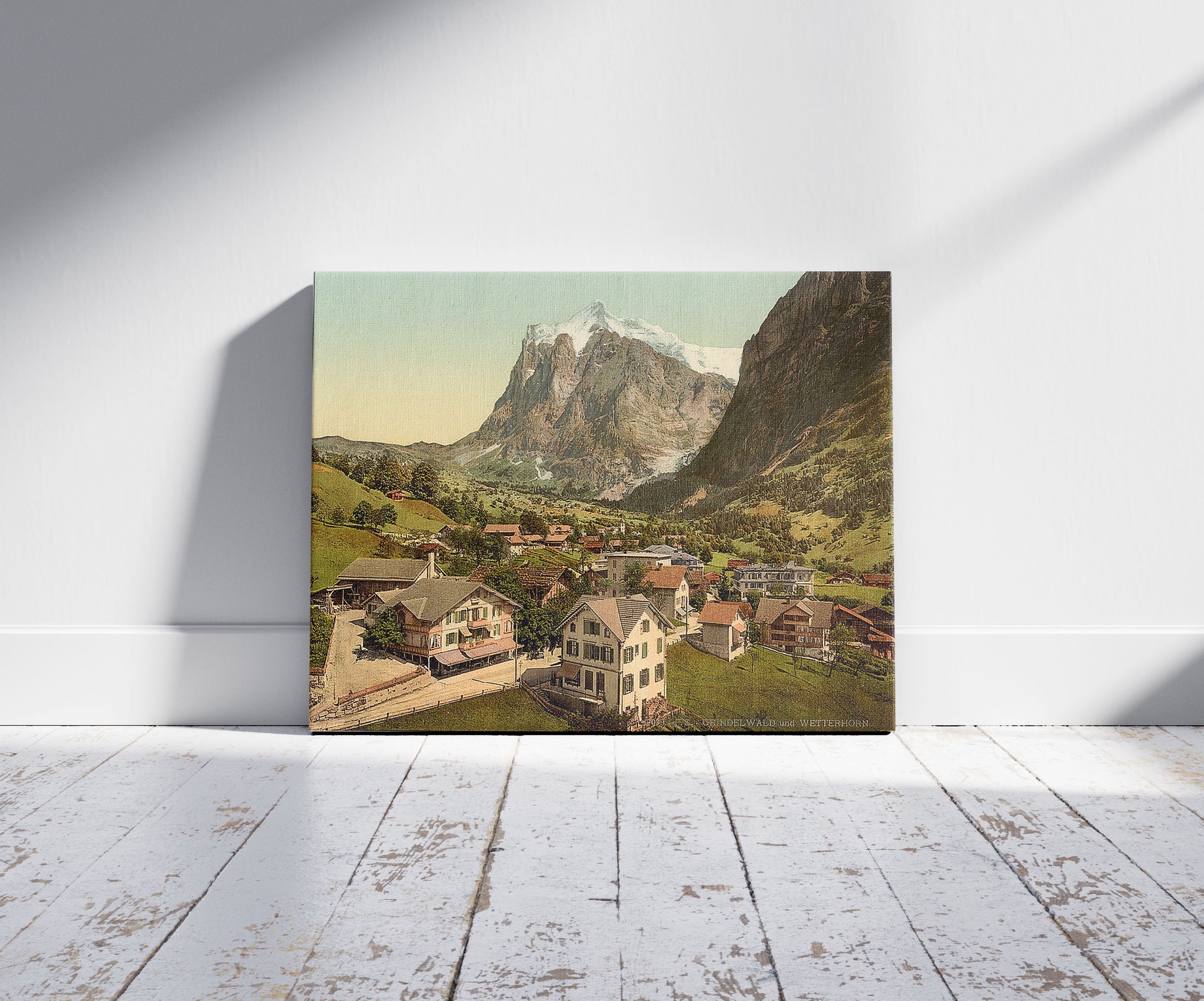A picture of Grindelwald and Wetterhorn Mountain, Bernese Oberland, Switzerland, a mockup of the print leaning against a wall
