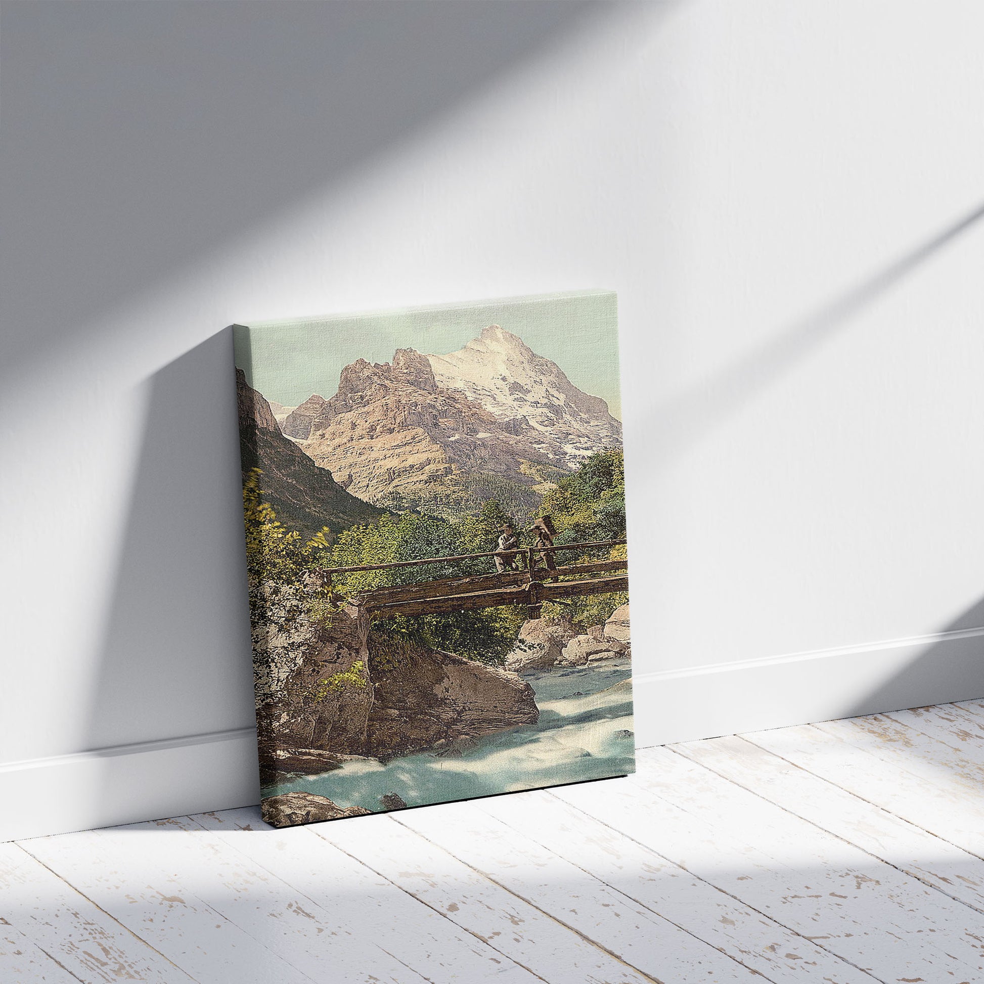 A picture of Grindelwald, footbridge and mountain peaks, Bernese Oberland, Switzerland, a mockup of the print leaning against a wall