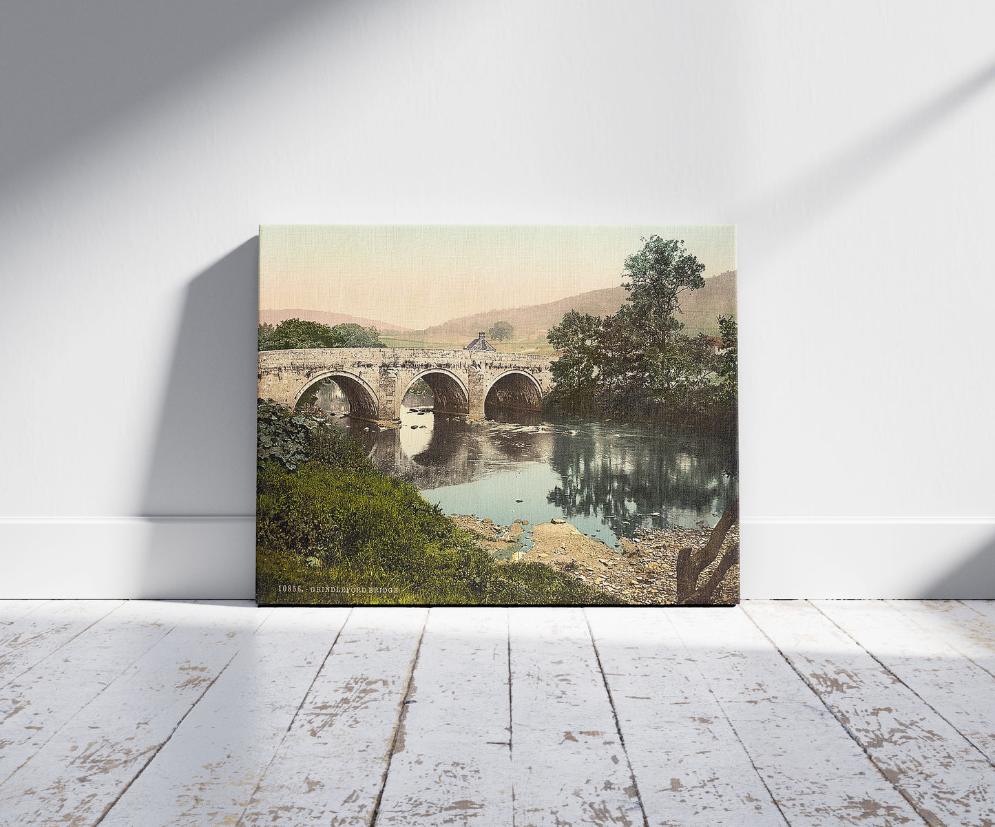 A picture of Grindleford Bridge, Derbyshire, England, a mockup of the print leaning against a wall