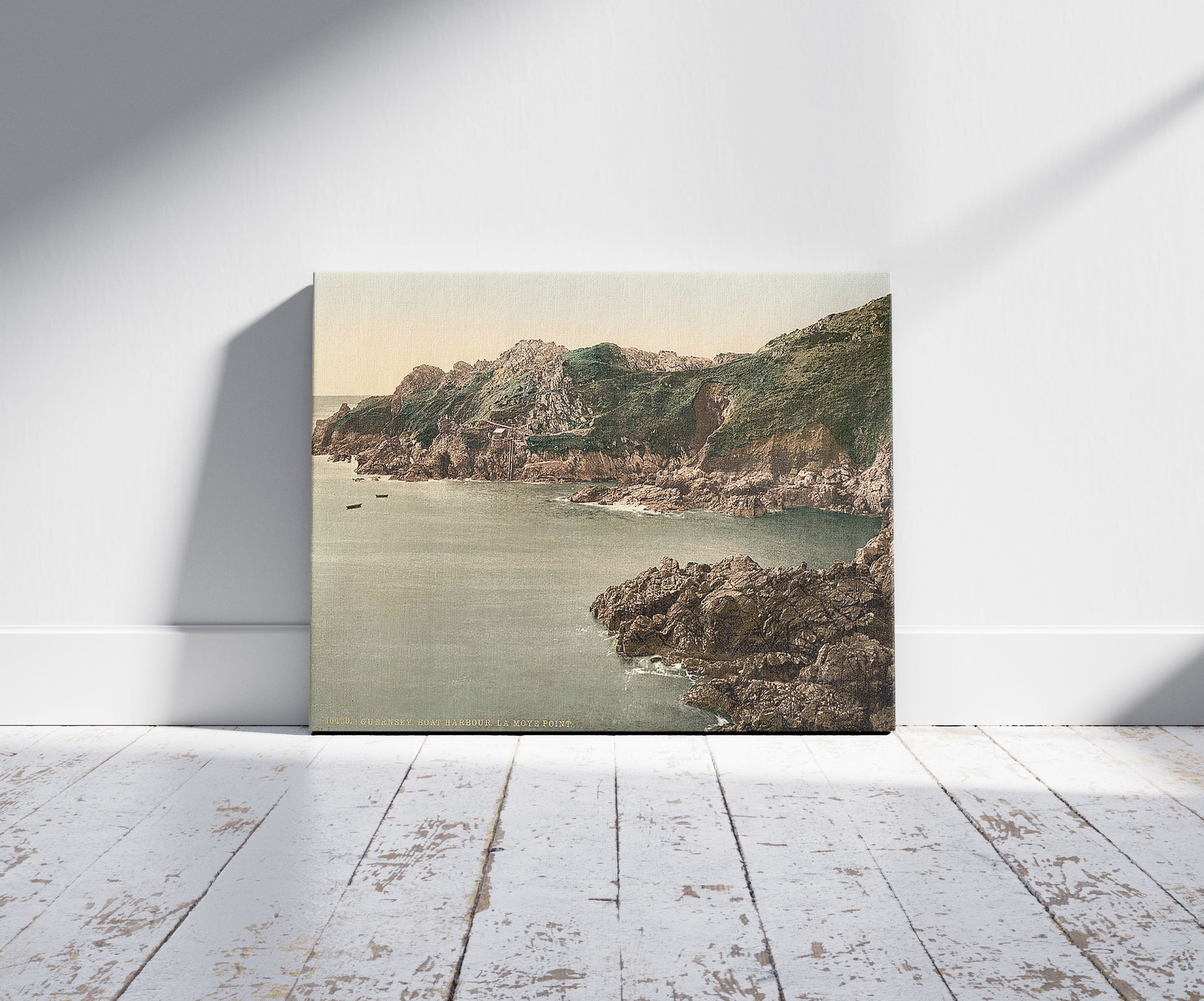 A picture of Guernsey, boat harbor, La Moye Point, Channel Islands, a mockup of the print leaning against a wall