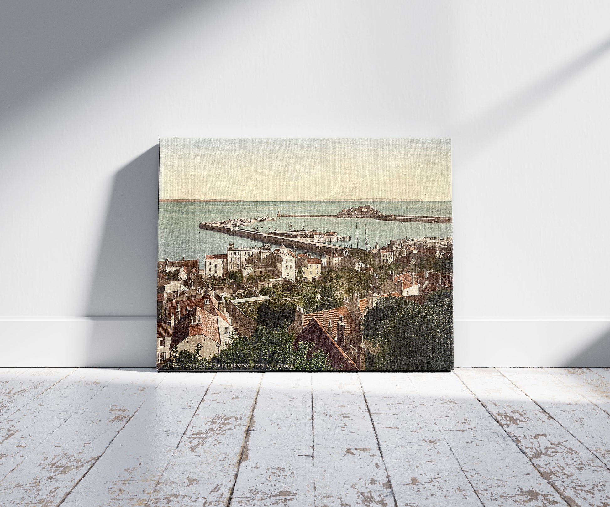 A picture of Guernsey, St. Peter's Port, general view of harbor, Channel Islands, a mockup of the print leaning against a wall