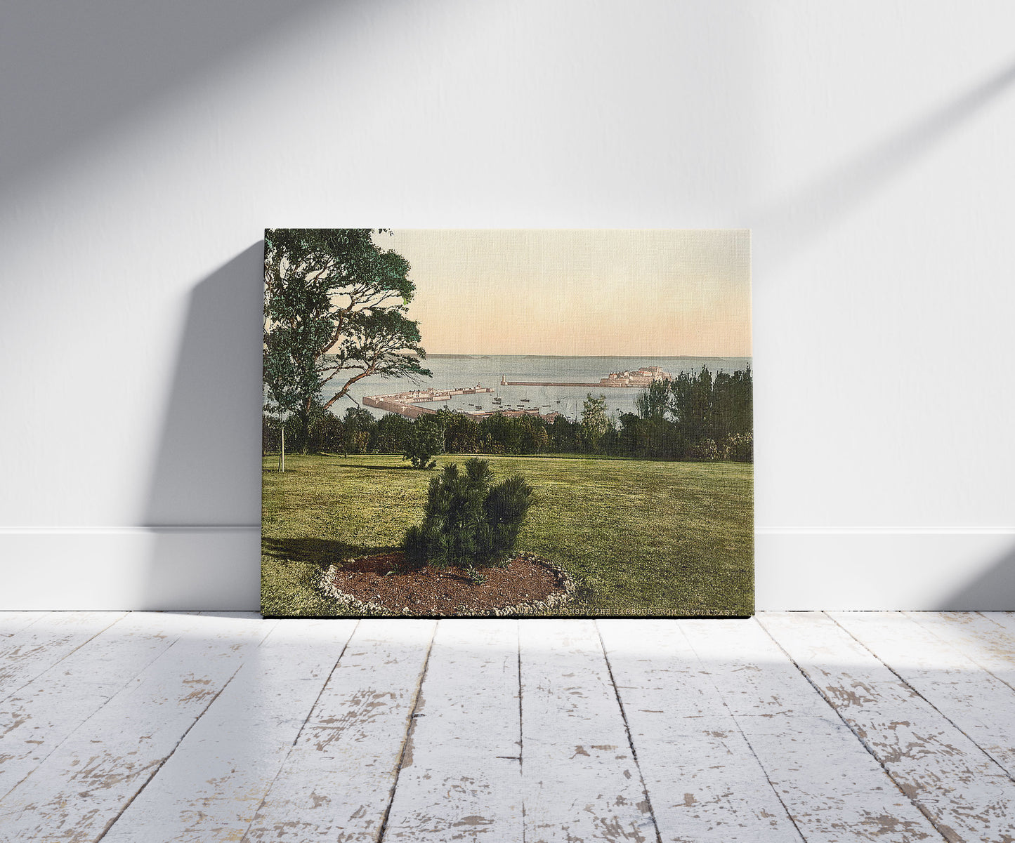 A picture of Guernsey, the harbor from Castle Cary, Channel Islands, a mockup of the print leaning against a wall