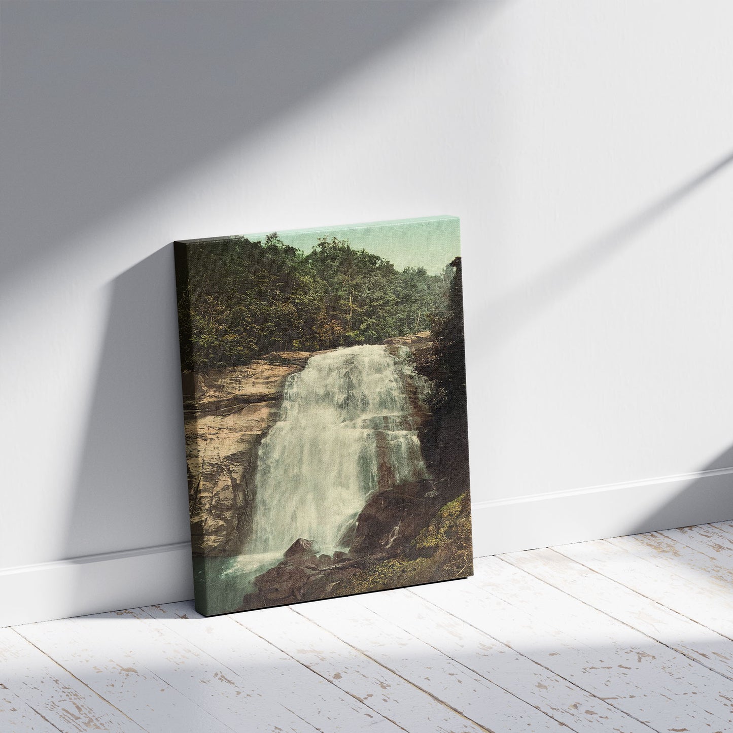 A picture of Horse Pasture Falls, Sapphire, N.C., a mockup of the print leaning against a wall