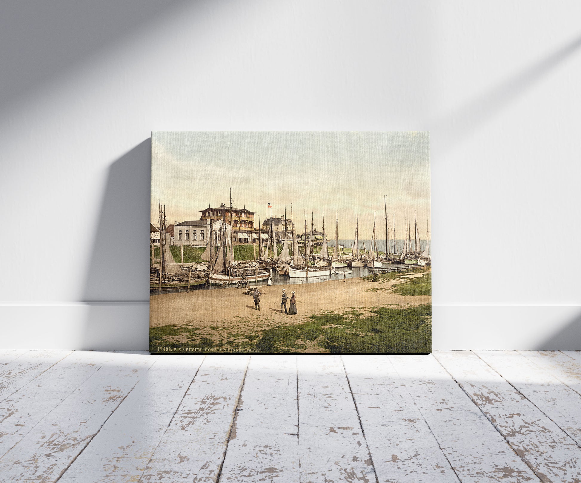A picture of Hotels and inland harbor, Busum, Schleswig-Holstein, Germany, a mockup of the print leaning against a wall