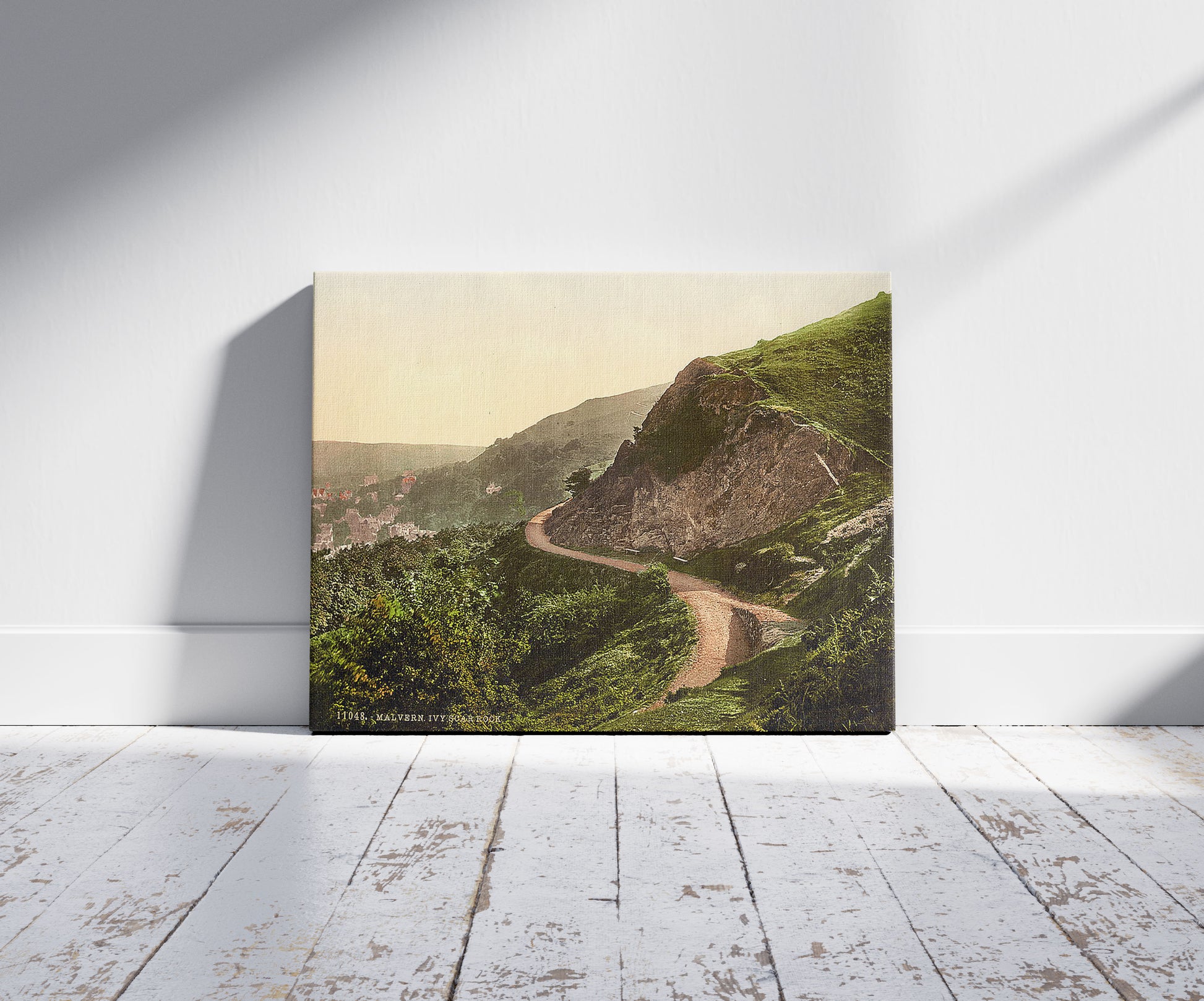 A picture of Ivy Scar Rock, Malvern, England, a mockup of the print leaning against a wall