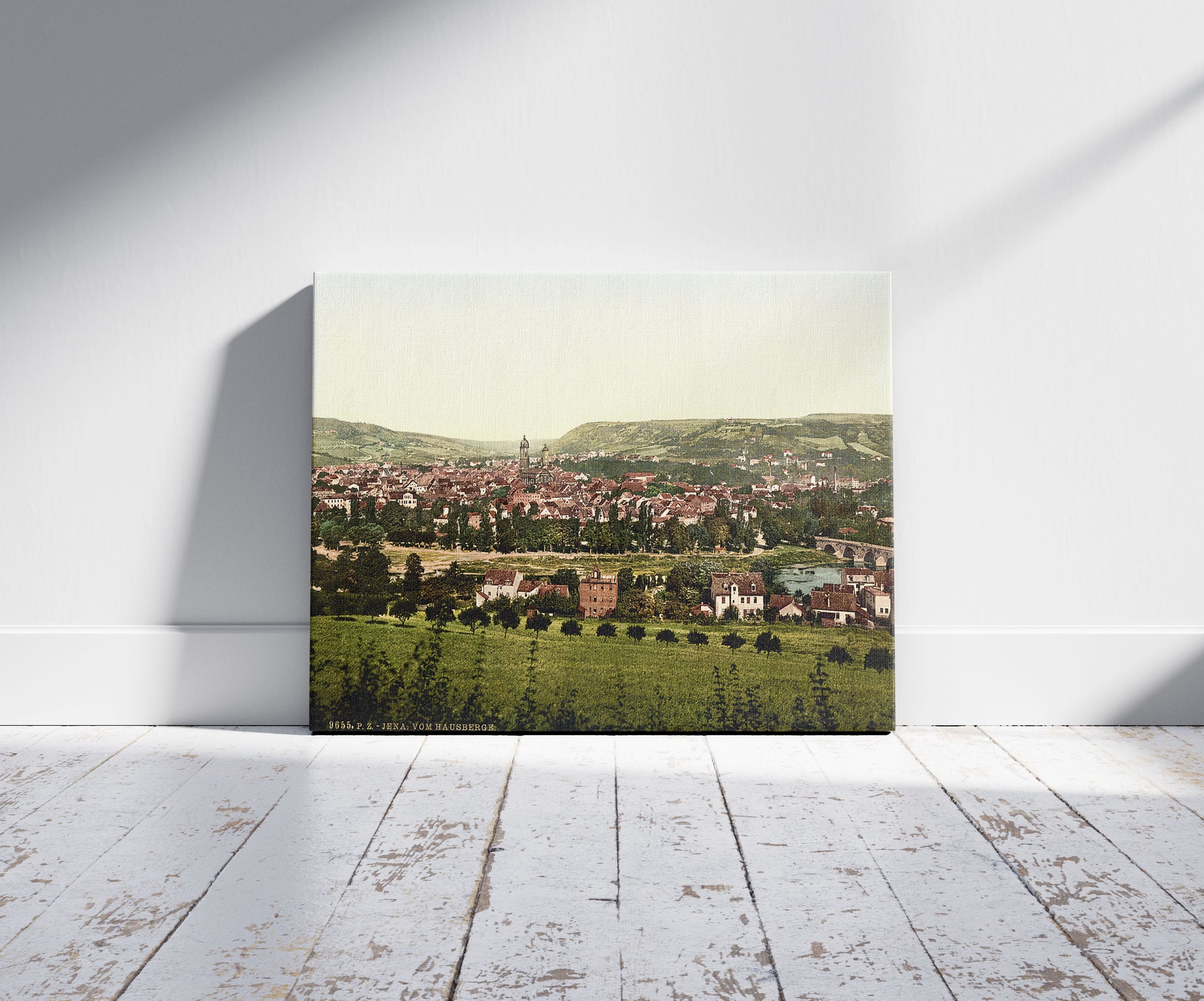 A picture of Jena, from Hansberge (i.e, Hausberge), Thuringia, Germany, a mockup of the print leaning against a wall