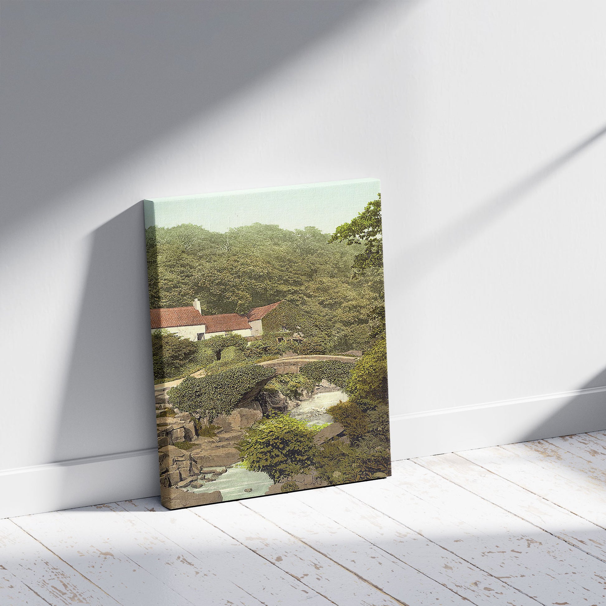 A picture of Jesmond Dene, old mill, Newcastle-on-Tyne, England, a mockup of the print leaning against a wall