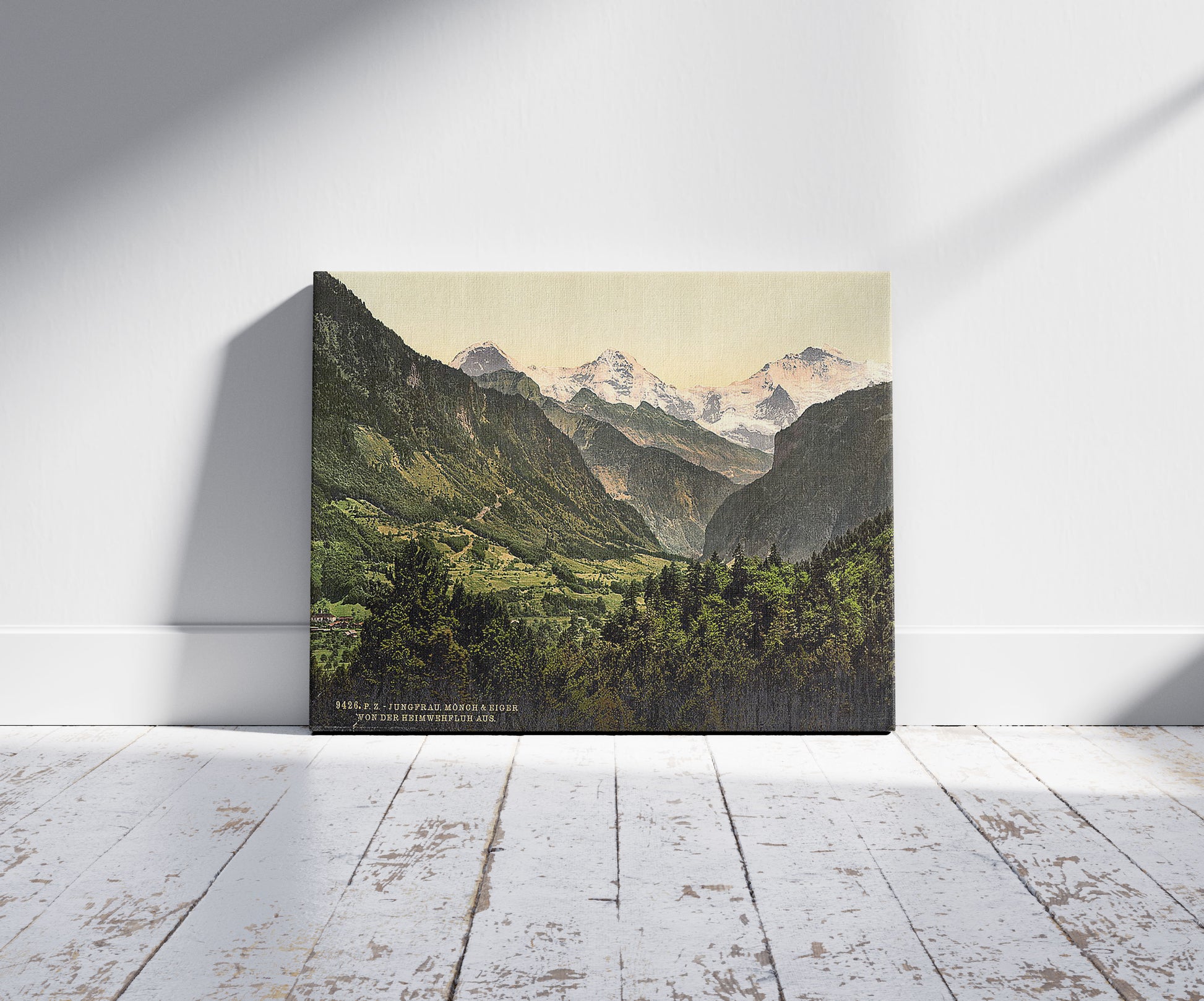 A picture of Jungfrau, Monch and Eiger, from Heimwehfluh, Bernese Oberland, Switzerland, a mockup of the print leaning against a wall