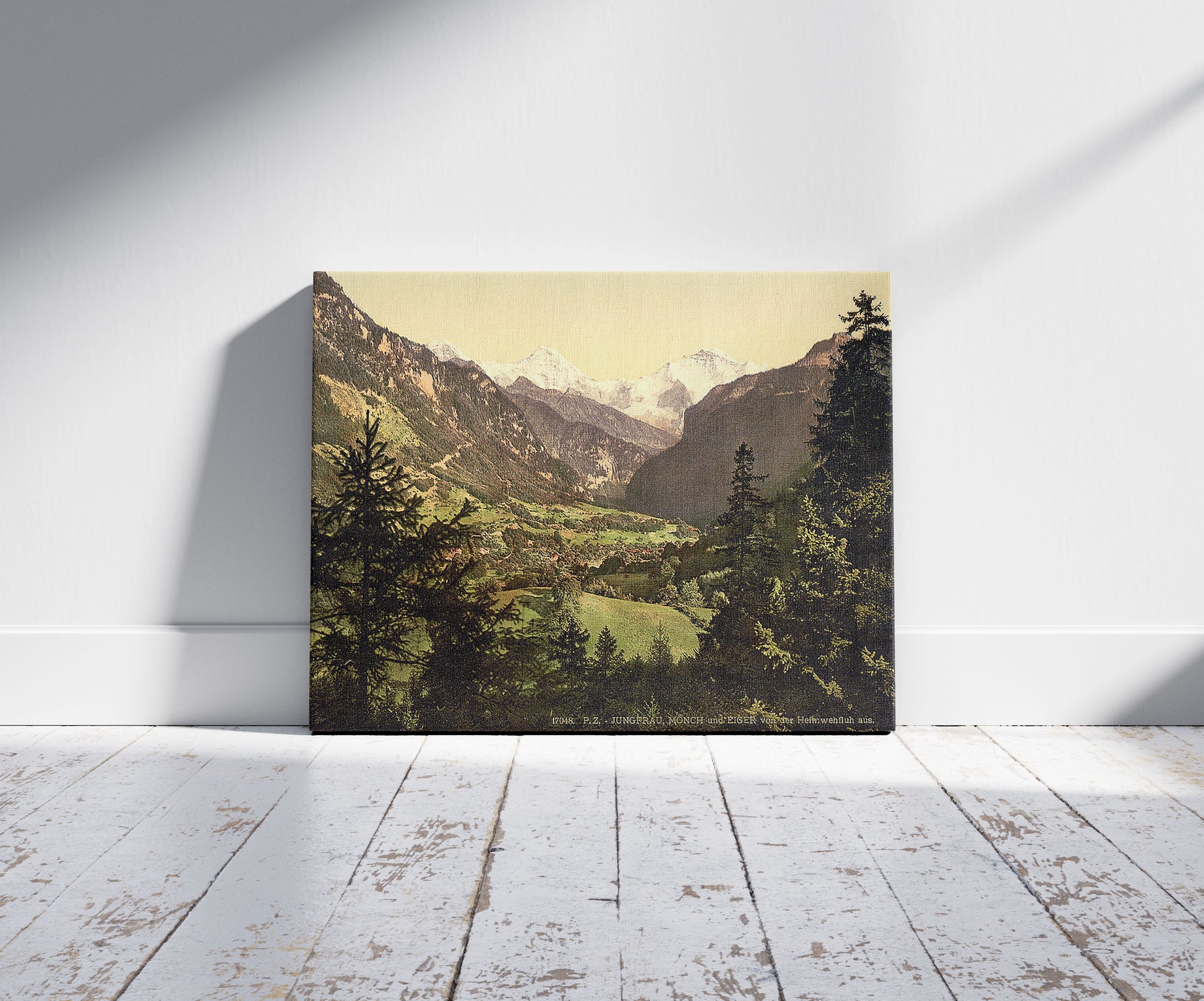 A picture of Jungfrau, Monch and Eiger Mountains, Bernese Oberland, Switzerland, a mockup of the print leaning against a wall
