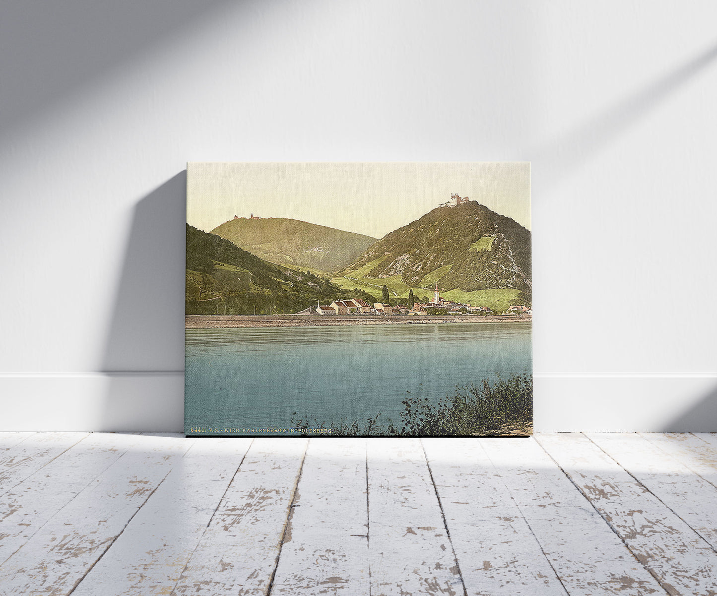 A picture of Kahlenberg and Leopoldsberg, Vienna, Austro-Hungary, a mockup of the print leaning against a wall