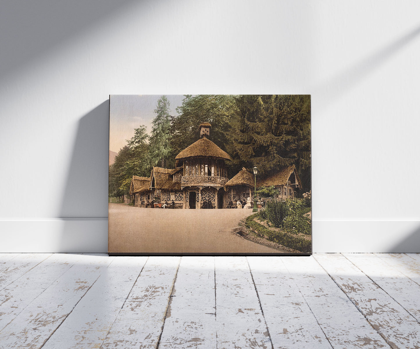 A picture of La Buvette du Pré, Luchon, Pyrenees, France, a mockup of the print leaning against a wall