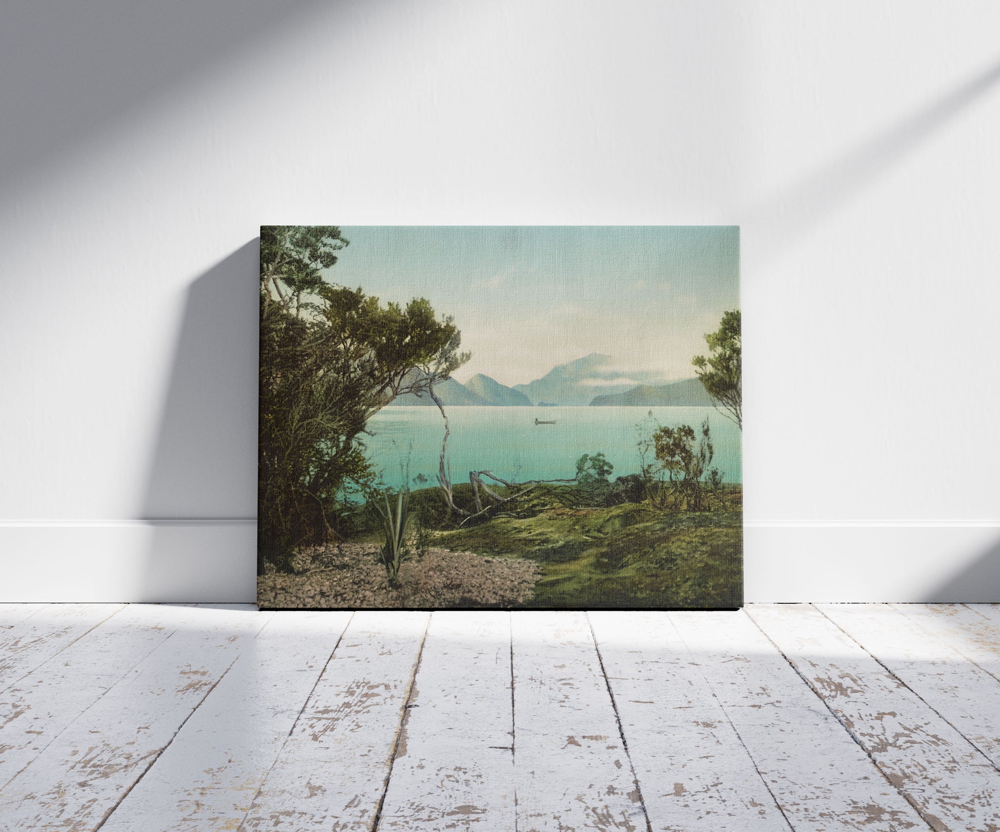 A picture of Lake Te Anau, a mockup of the print leaning against a wall