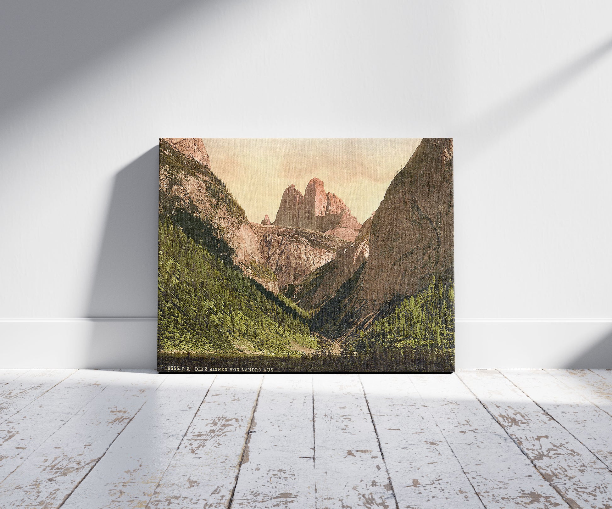 A picture of Landro, the Three Spires (i.e., Drei Zinnen), Tyrol, Austro-Hungary, a mockup of the print leaning against a wall
